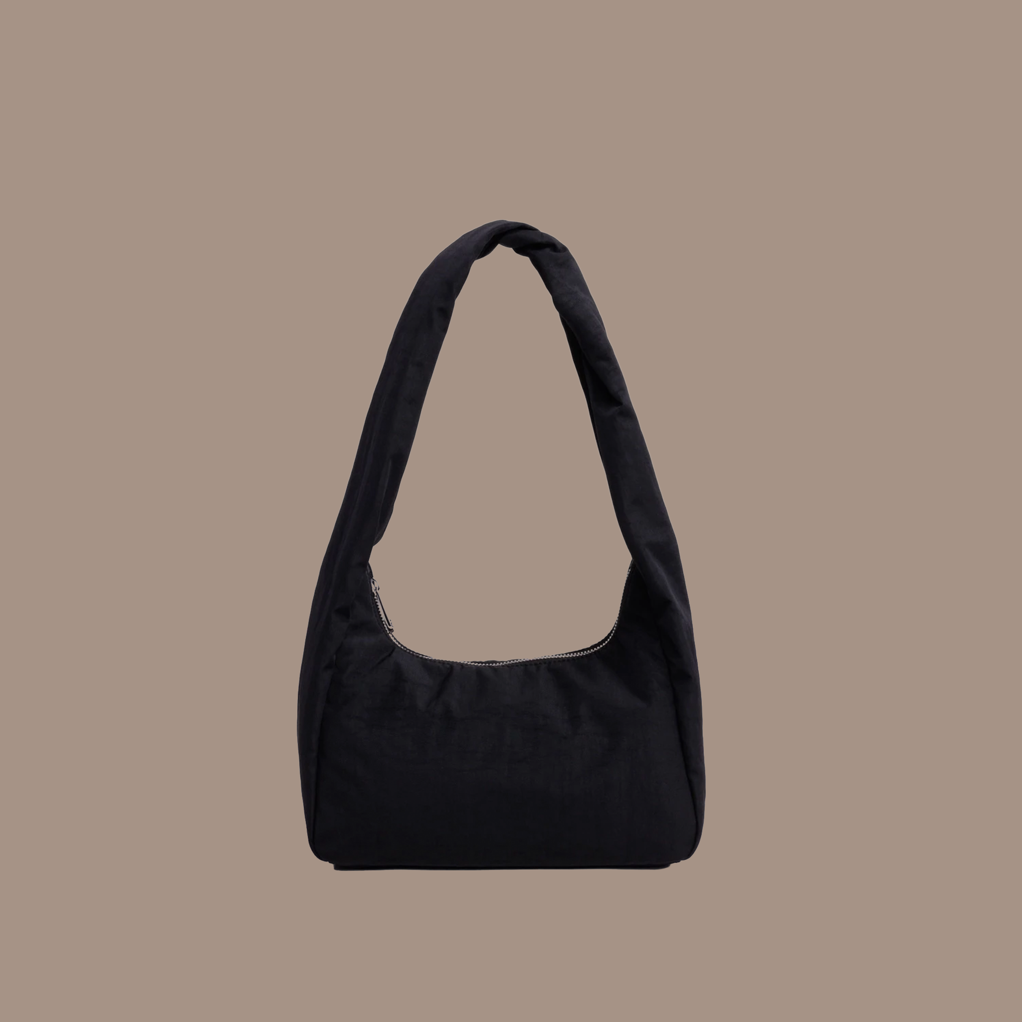 Black nylon purse on a brown background.