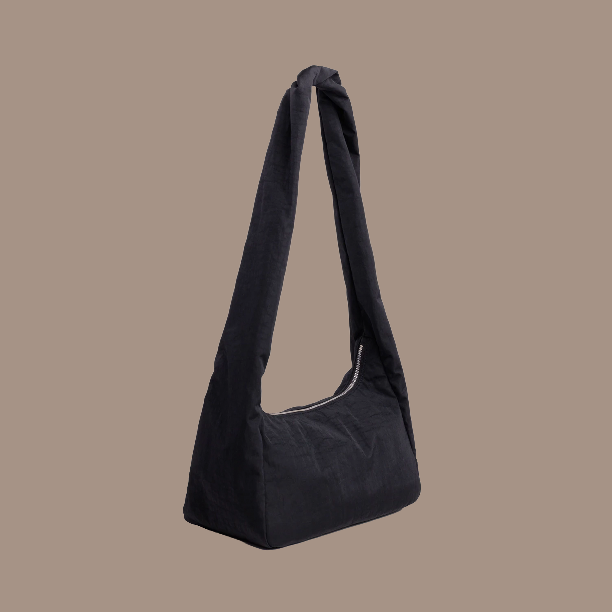 A black nylon shoulder bag with long shoulder straps. 