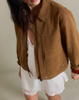 A brown suede jacket with front pockets. 