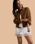 A brown suede jacket with front pockets. 