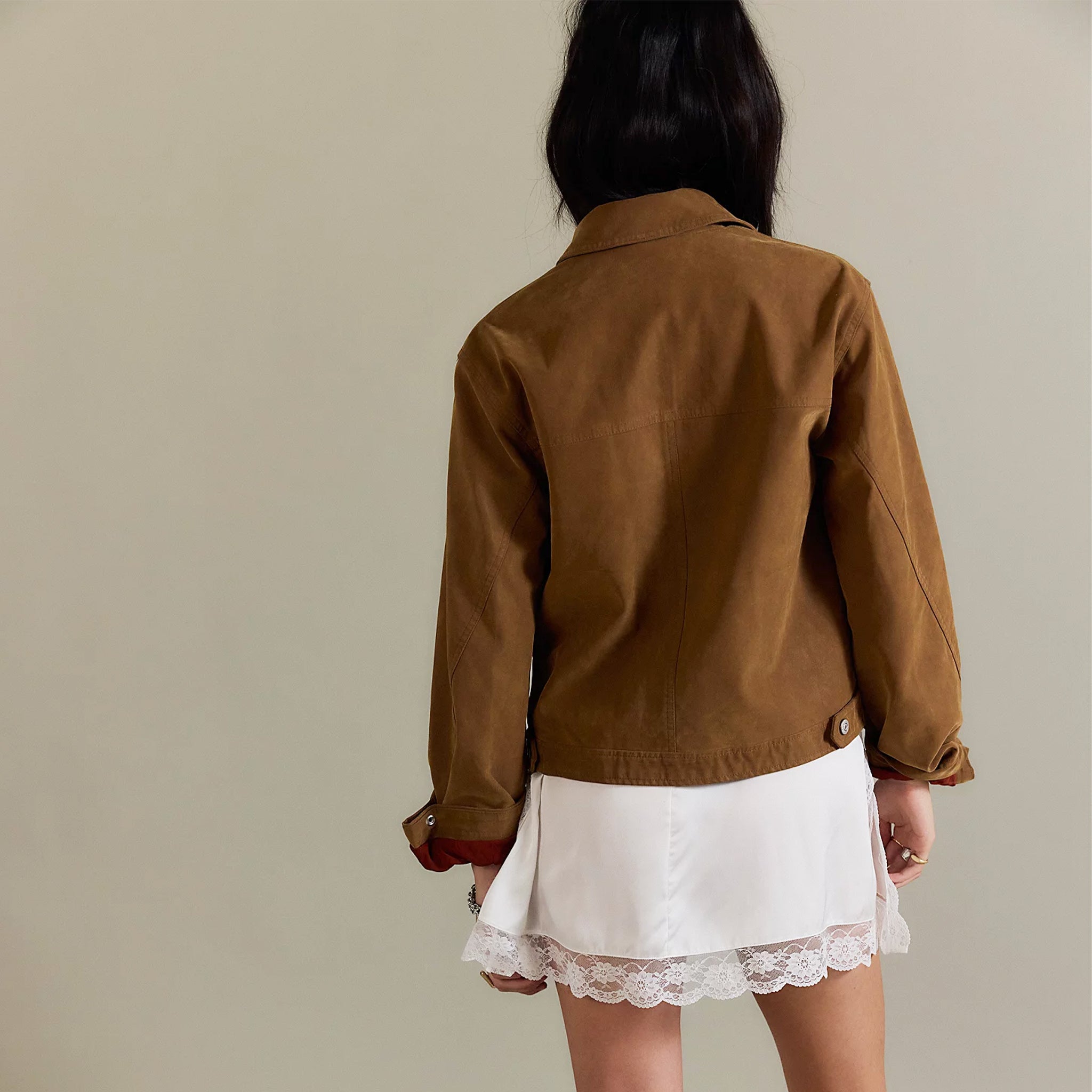 A brown suede jacket with front pockets. 