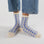 A pair of blue and ivory gingham printed crew socks. 