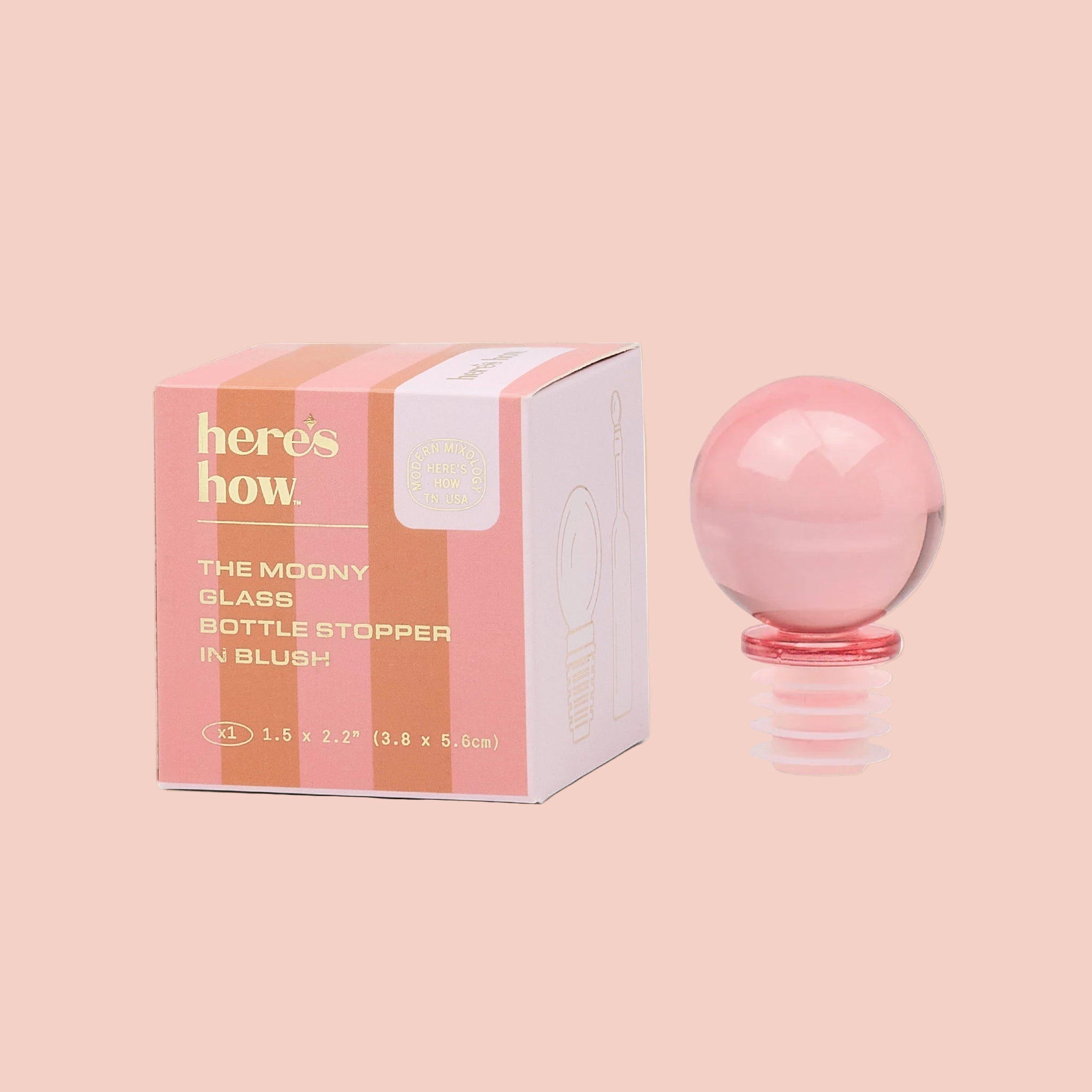 A pink glass round bottle stopper. 