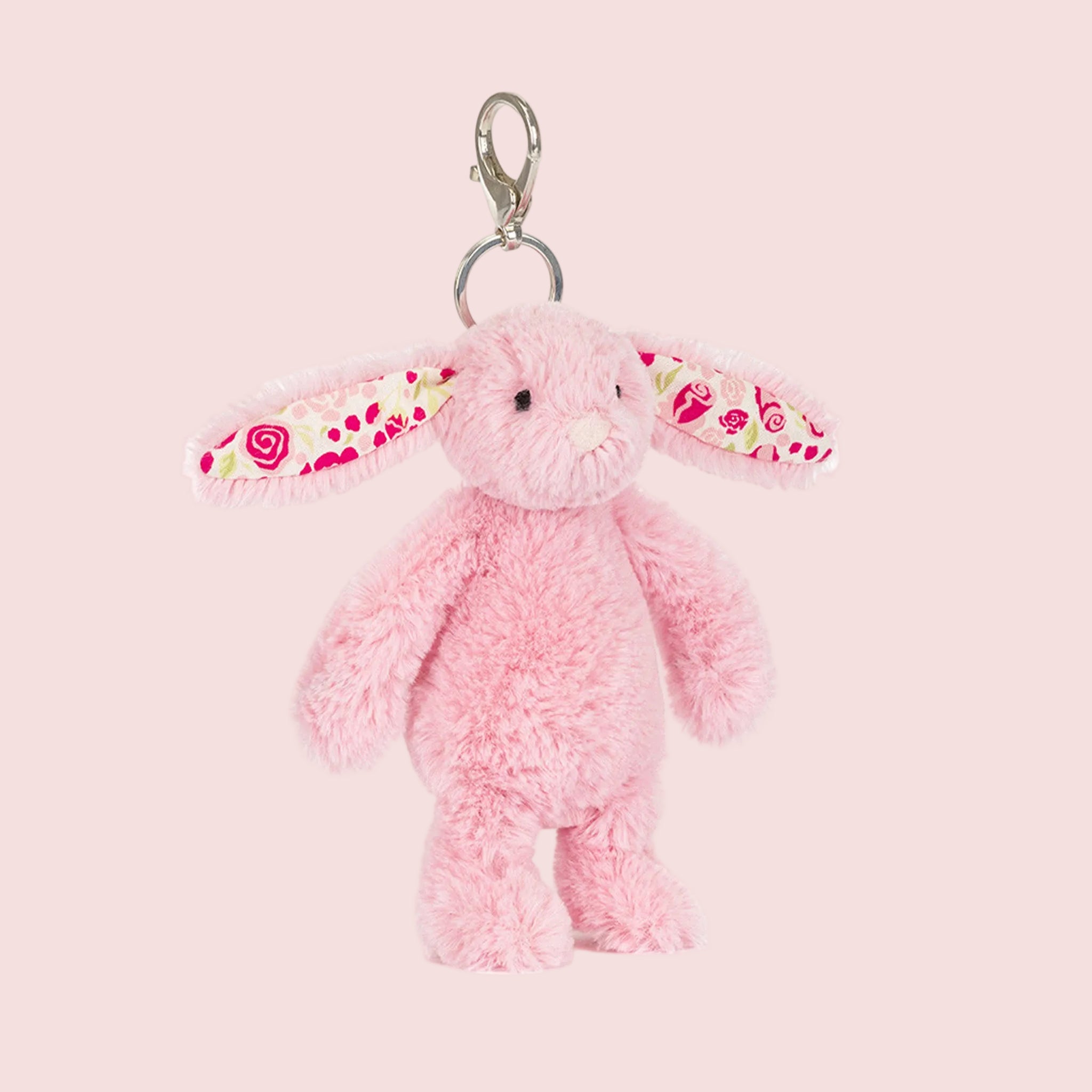 A pink bunny shaped stuffed animal keychain bag charm. 