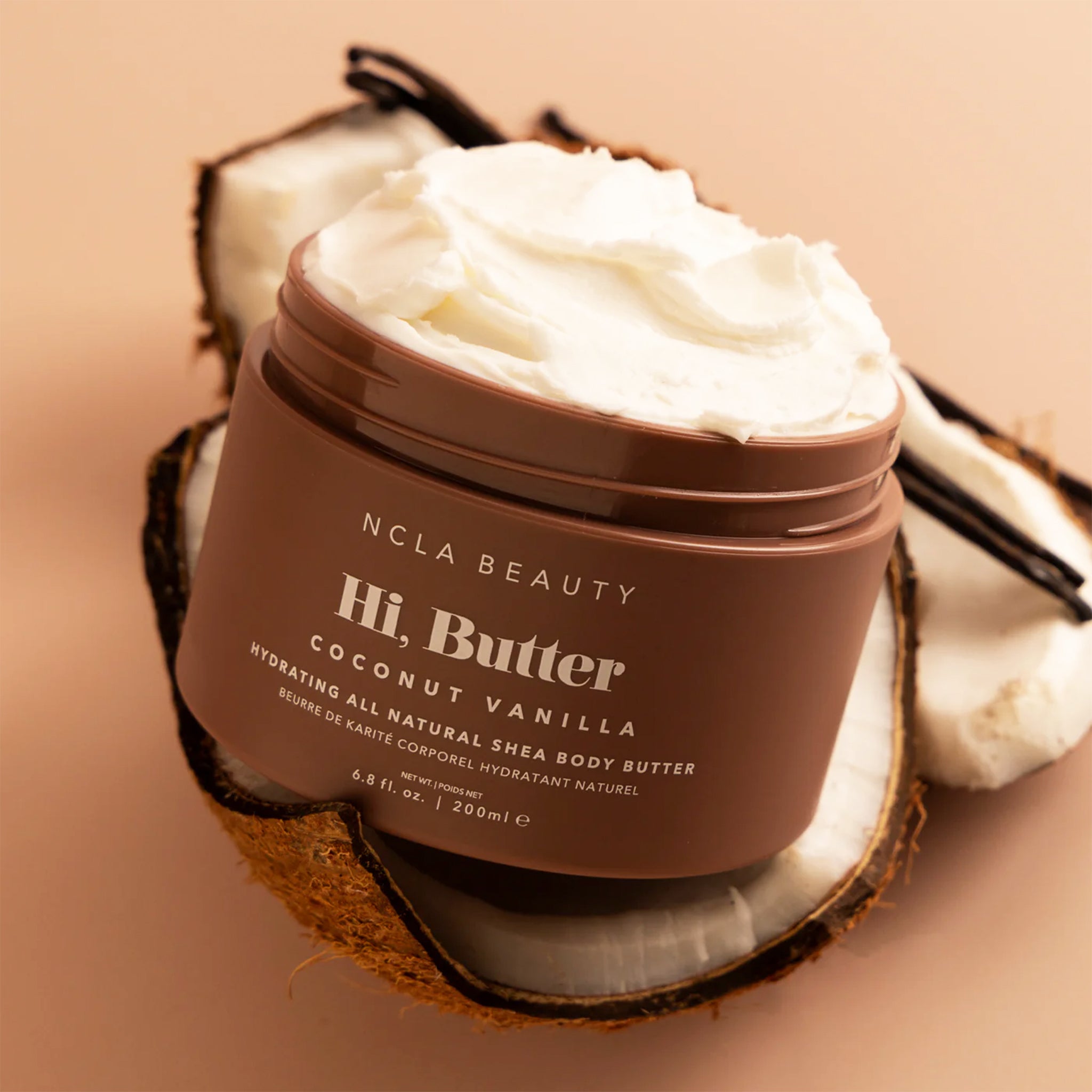 A brown jar of body butter in a coconut vanilla scent.