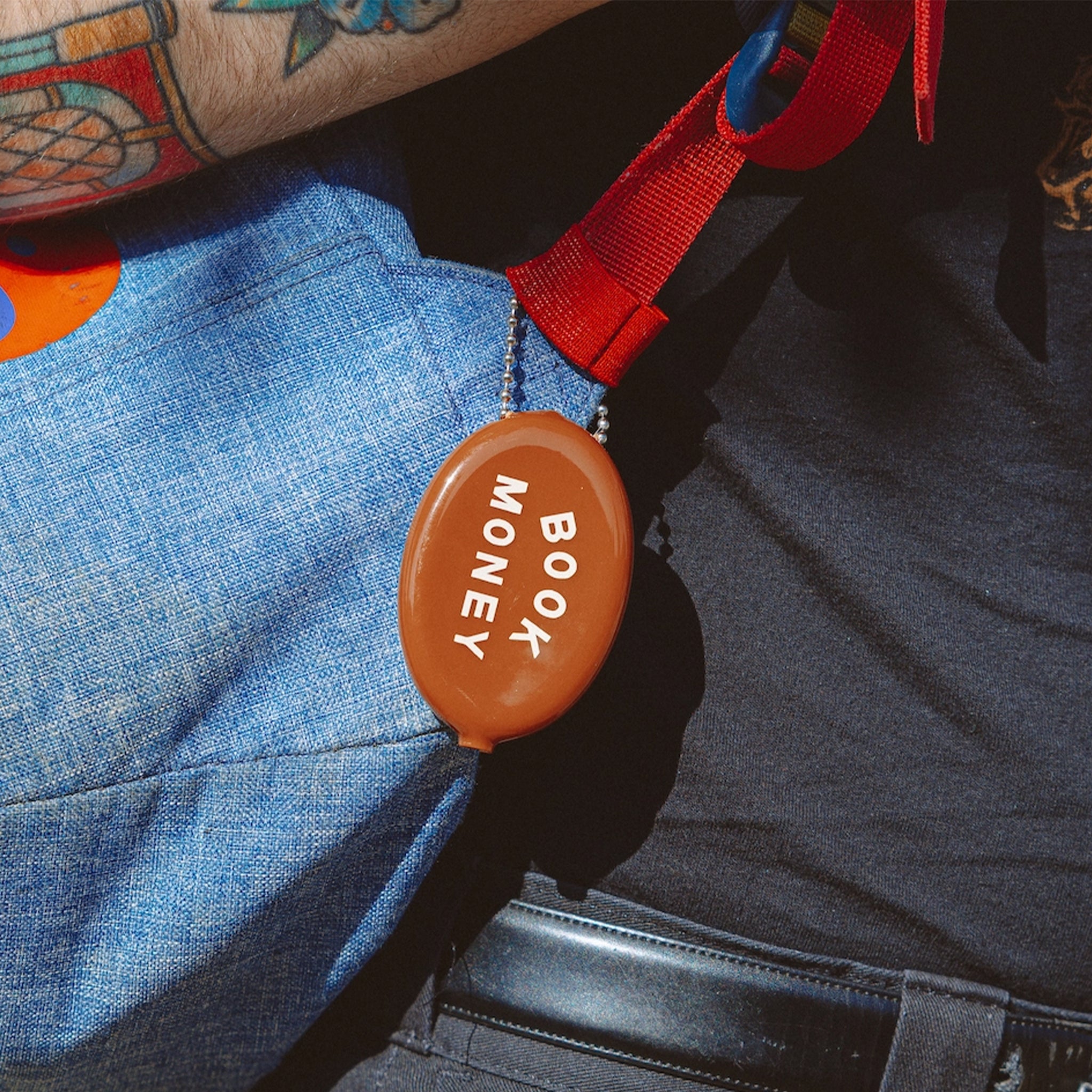 Brown coin purse with 'BOOK MONEY' text on a brown background.