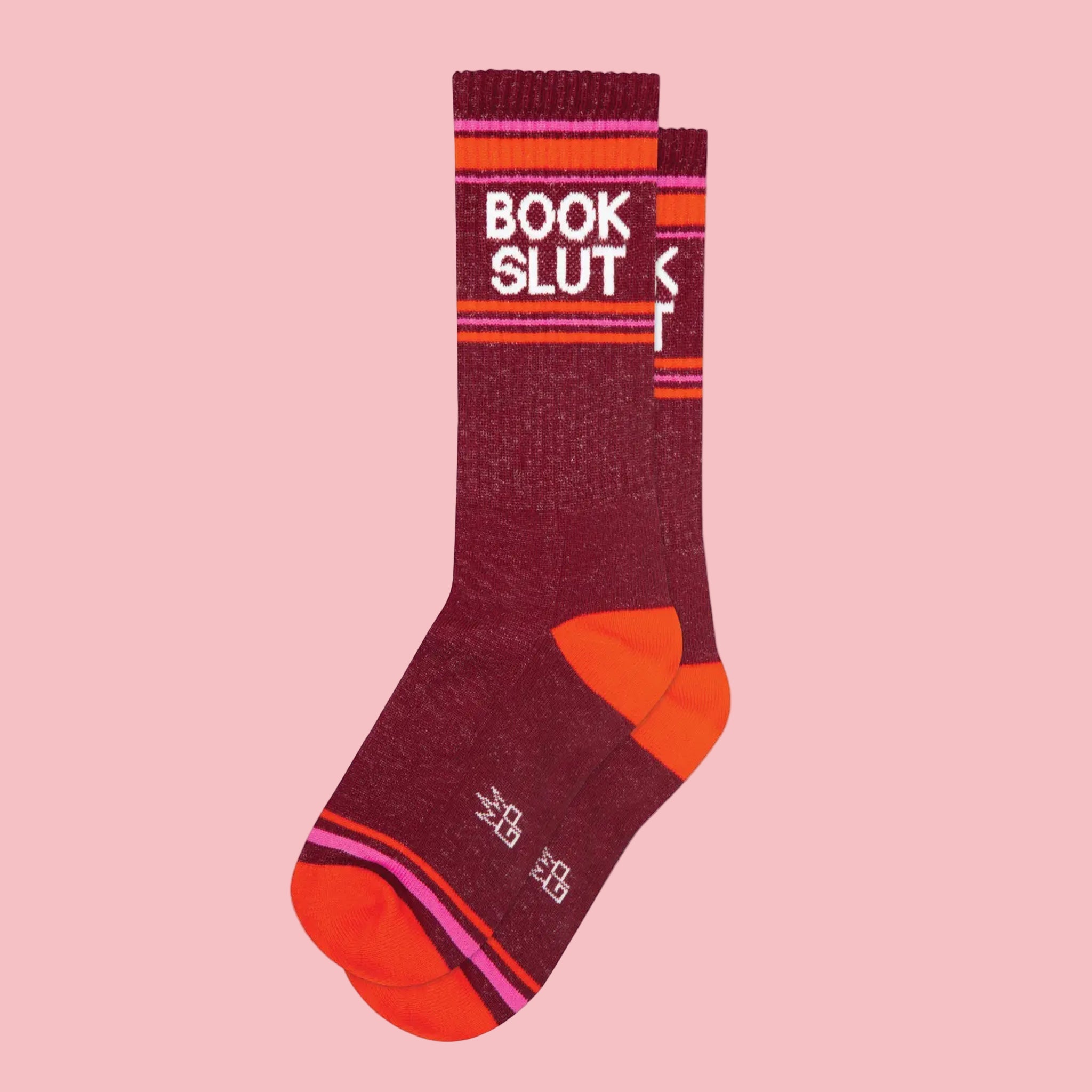 a pair of red socks that say "book slut" on them.
