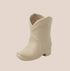 A tan ceramic boot shaped candle. 