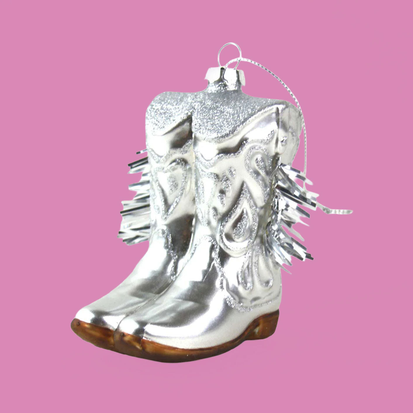 A silver pair of cowboy boot shaped ornament. 
