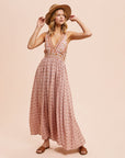 A dusty pink floral maxi dress with a v-neckline and a small slit at the bottom. 