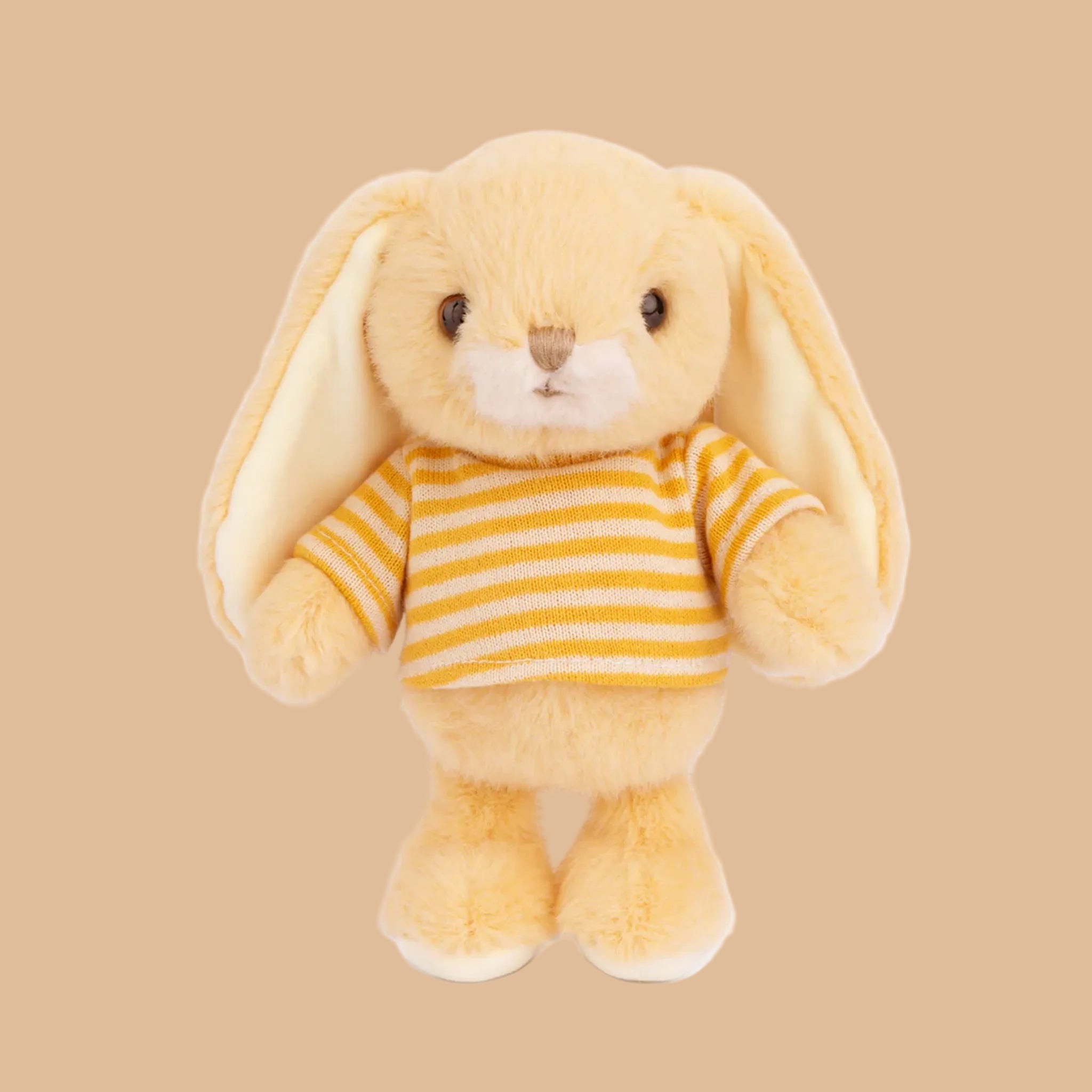A yellow bunny shaped stuffed toy with a striped shirt. 