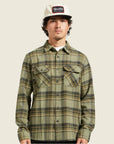 A green plaid flannel worn on a model. 