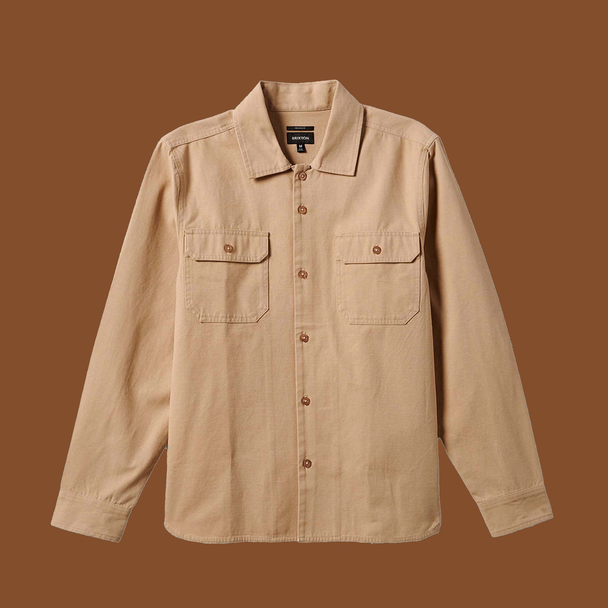 will neutral tan colored button up shirt with a relaxed fit and chest pockets.