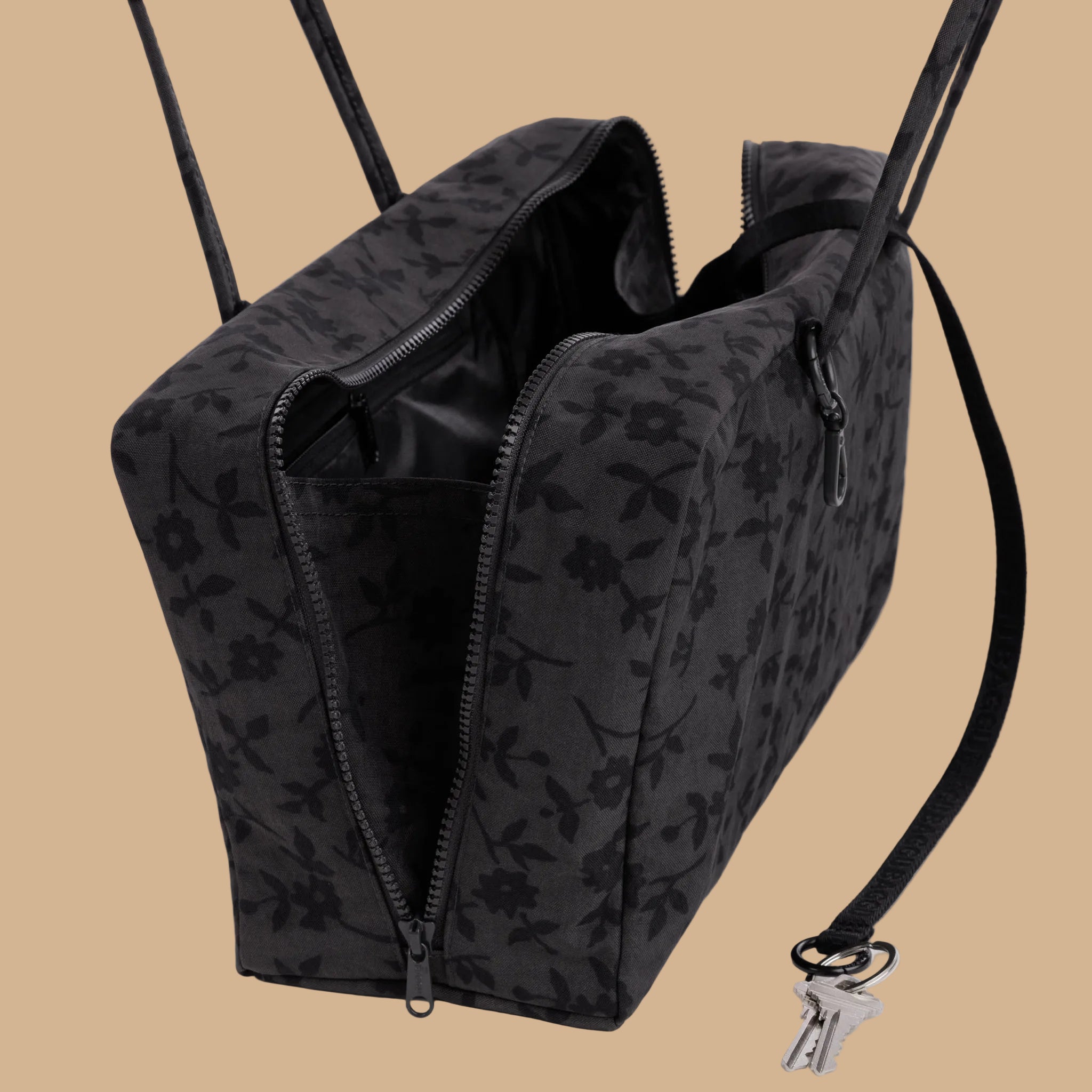 A nylon shoulder bag with a floral pattern.