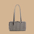 A cream and black gingham print shoulder bag.