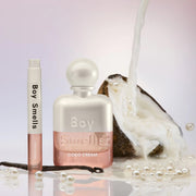 A white shimmery bottle of perfume with text that reads, 'Boy Smells Coco Cream'. 