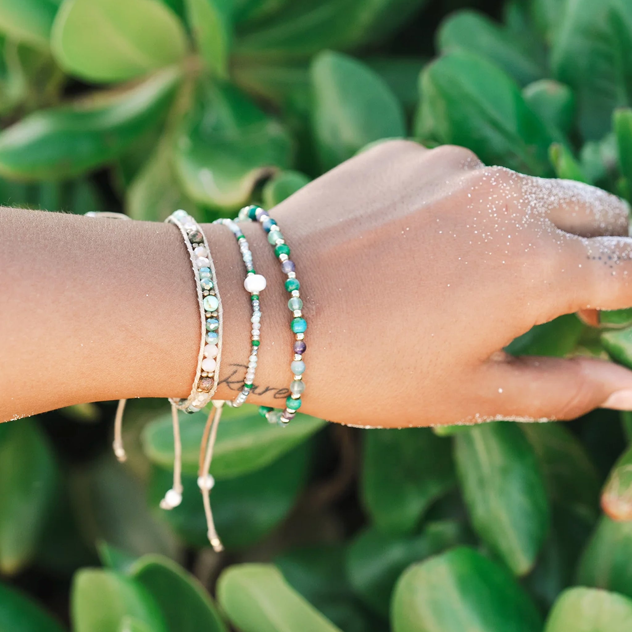 A beaded turquoise, white and green bracelet. 