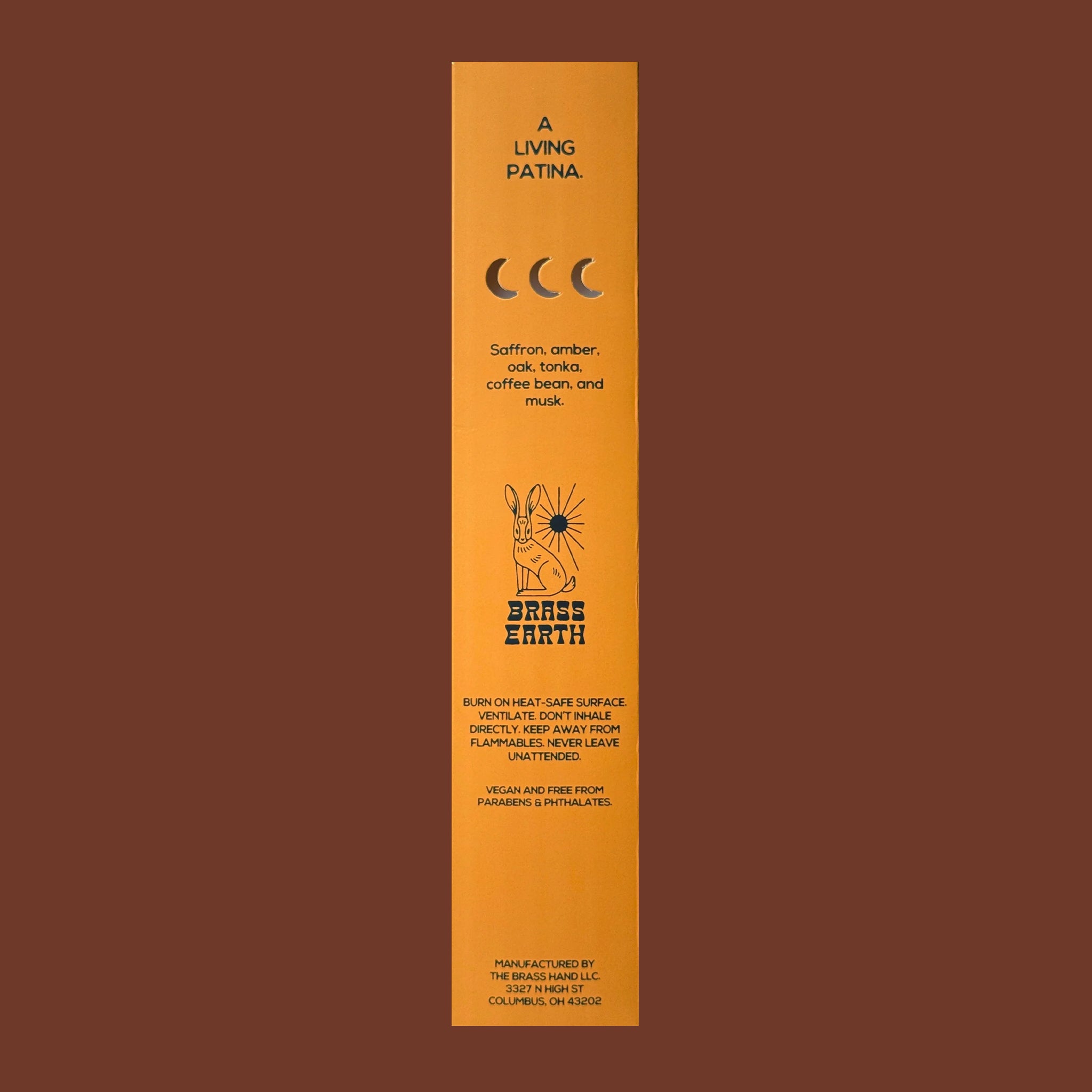 Orange incense stick packaging with text and branding on a brown background