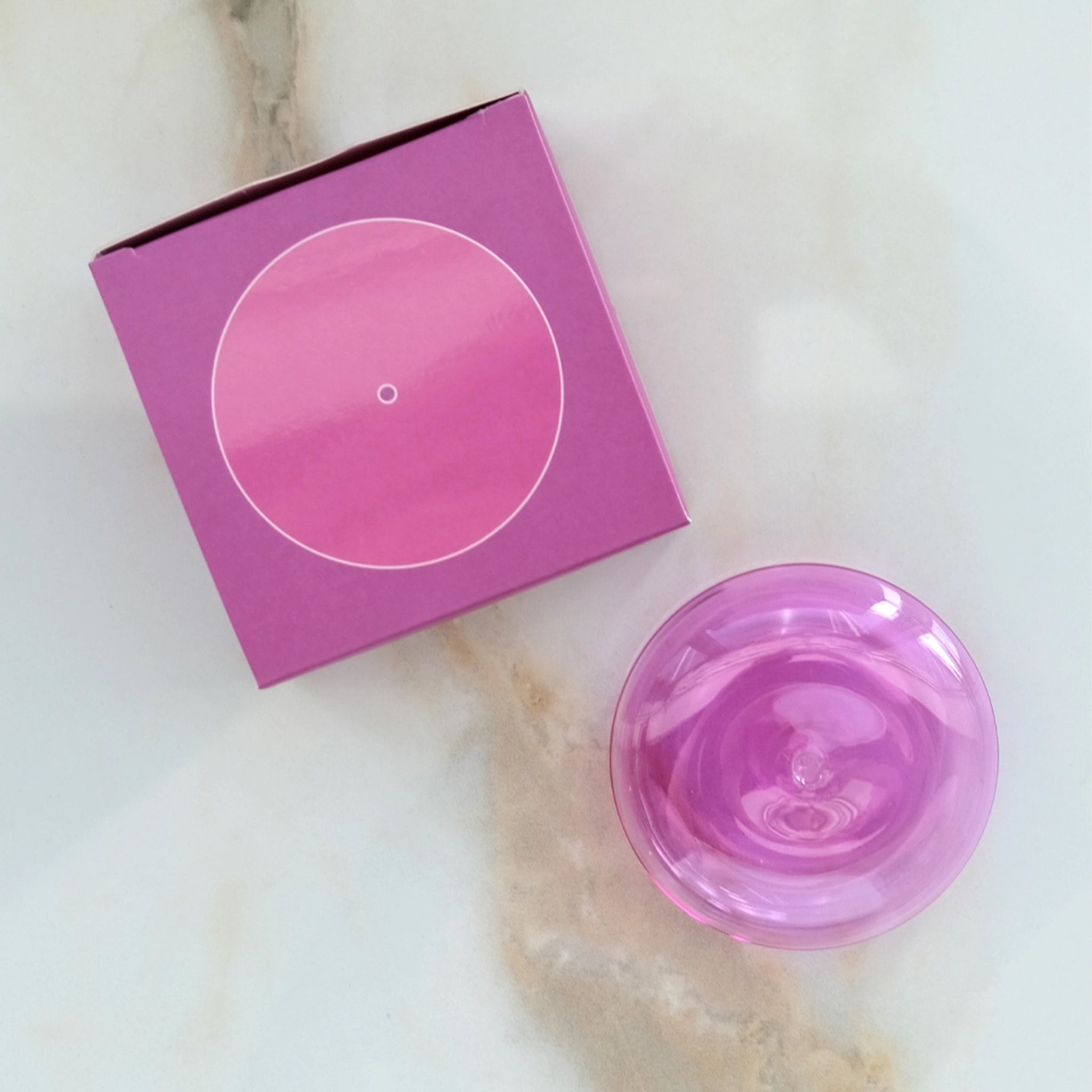 An orchid pink glass bubble incense holder. 