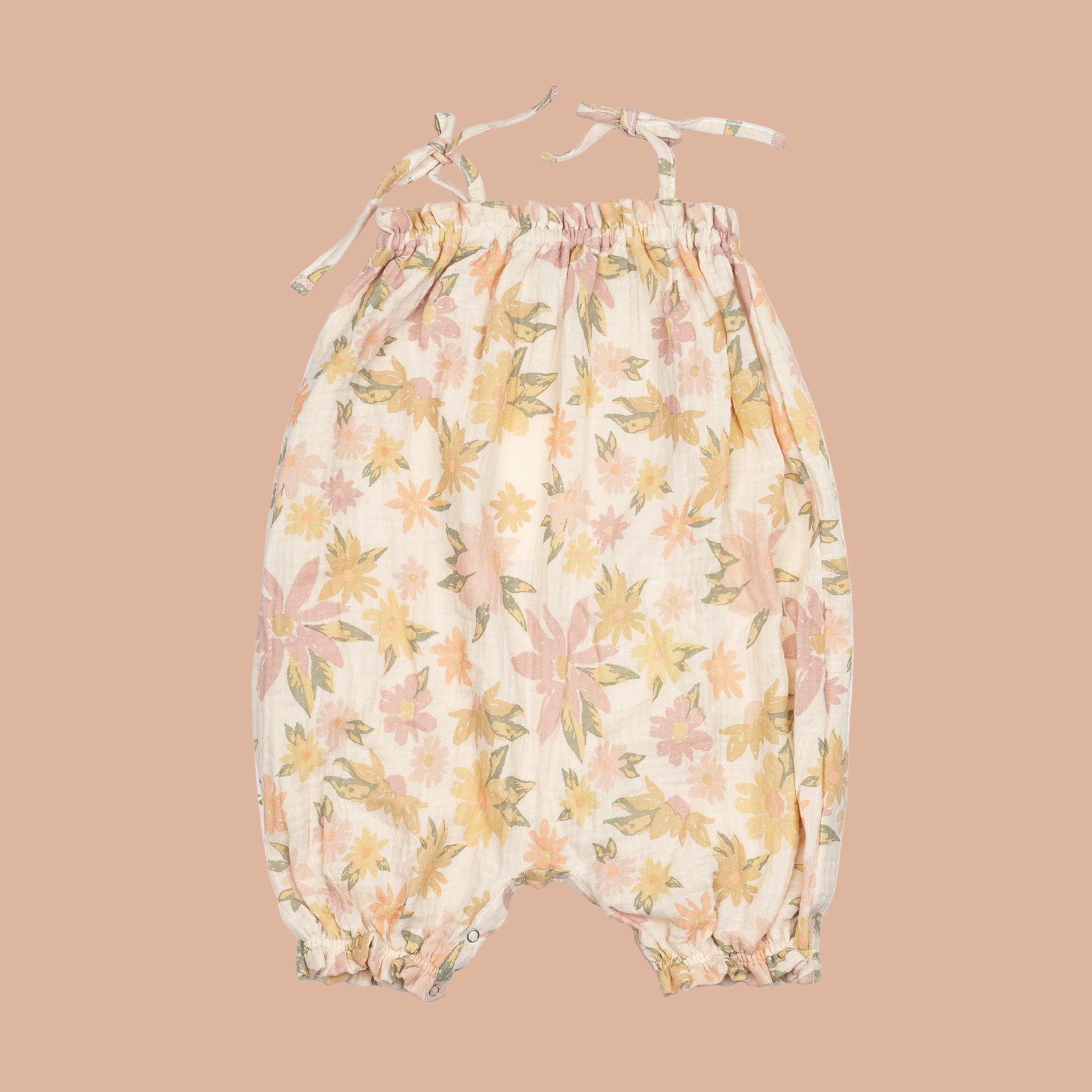 An ivory floral romper with tie shoulder straps. 