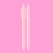 On a pink background is a light pink set of ballpoint pens. 