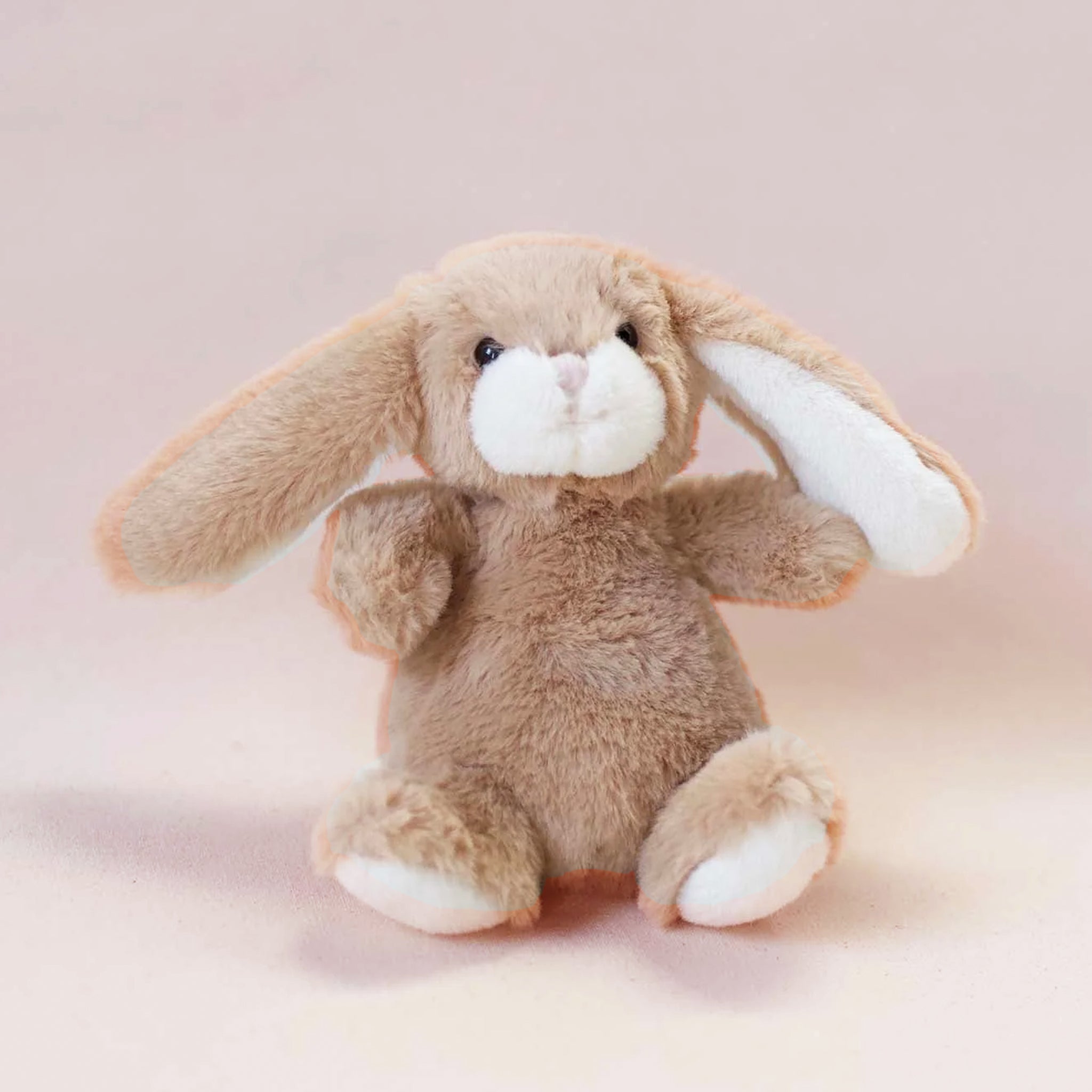 A tan bunny stuffed animal toy with floppy ears. 