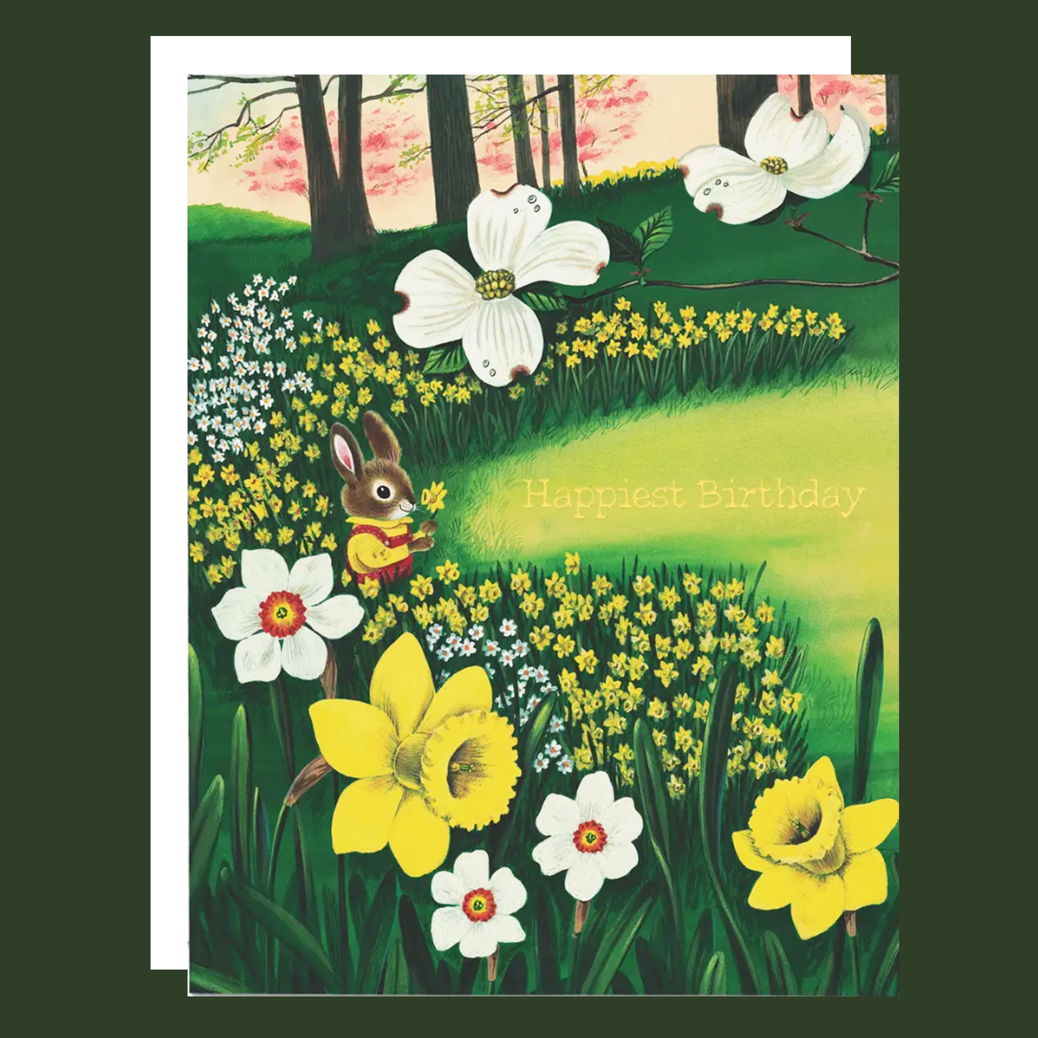 A square greeting card featuring a whimsical spring woodland scene with a rabbit in a yellow outfit, white dogwood flowers, yellow daffodils, and the text 'Harriest Birthday' on a green hillside. The card is shown with a white envelope against a dark green background.