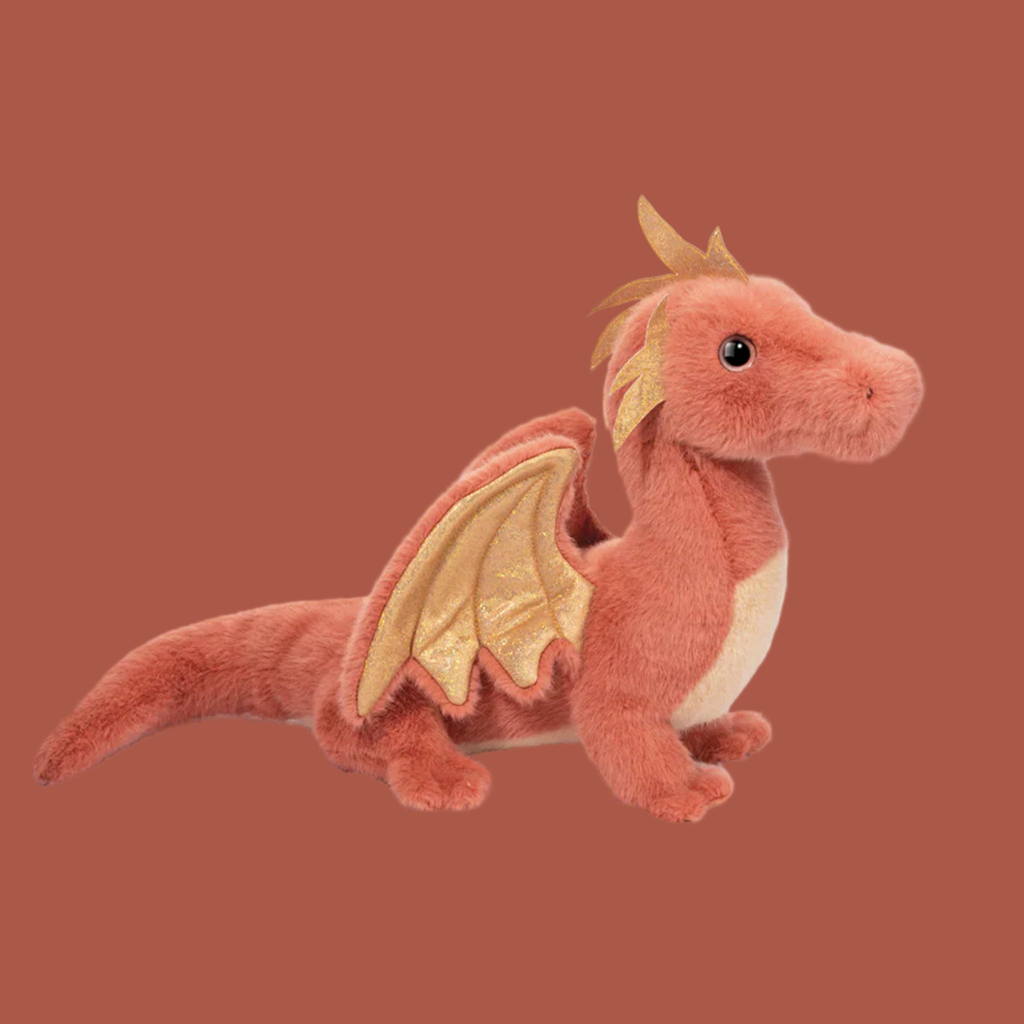 A dark pink dragon shaped stuffed animal toy. 
