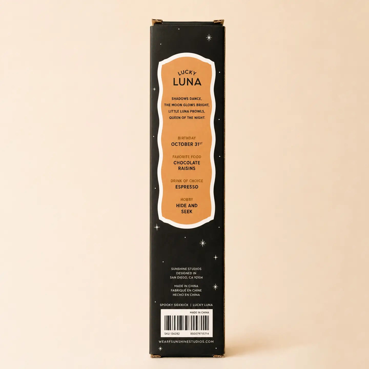 A packaged novelty sidekick doll labeled 'LUCKY LUNA SPOOKY SIDEKICK' by Sunshine Studios, shown in a tall black box with a gold-trimmed window and a black cat costumed doll inside. 