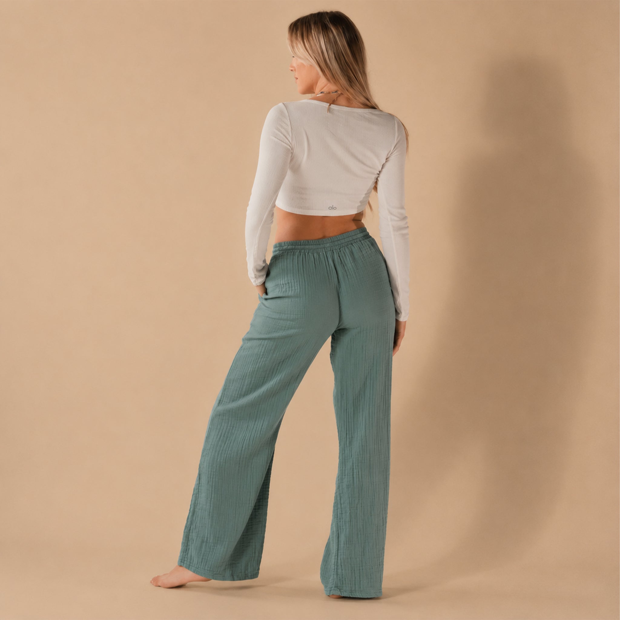 A pair of green cotton pants with a tie waistband. 