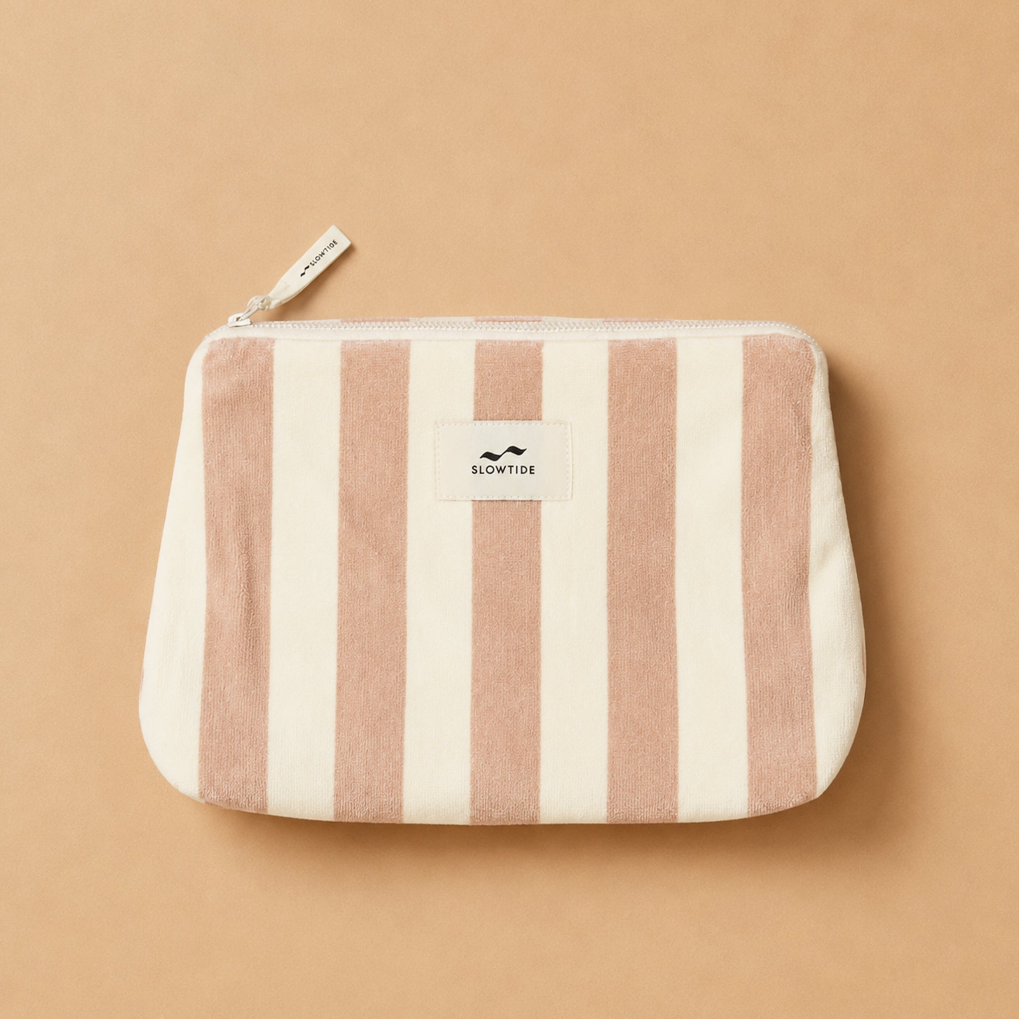 A light pink and cream striped terry pouch. 