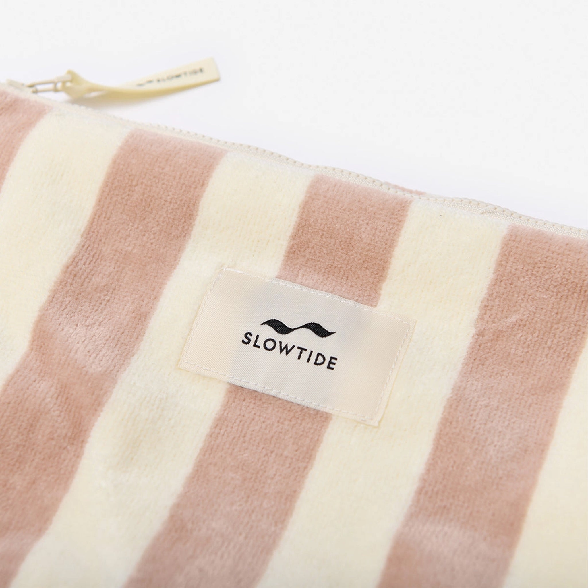 A light pink and cream striped terry pouch. 