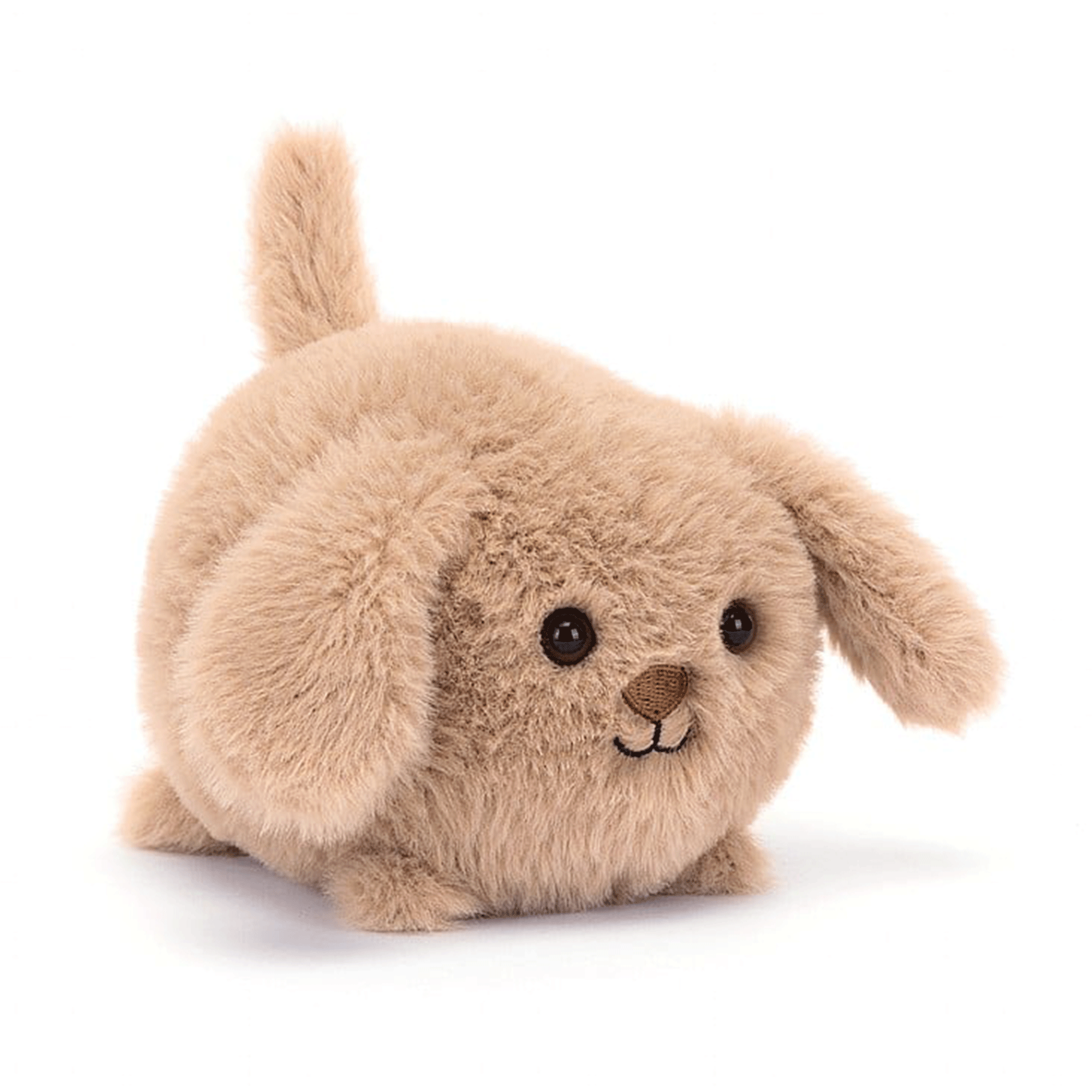 On a white background is a tan puppy stuffed toy puppy with a round body and floppy ears. 