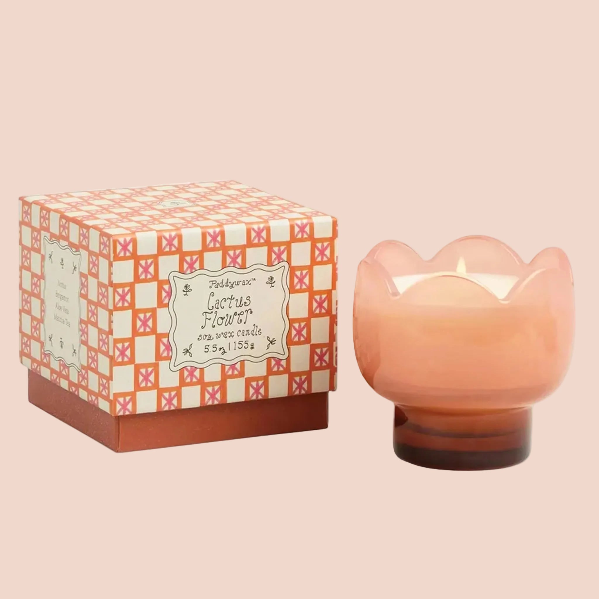 A light orange/peachy pink tulip shaped glass candle. 