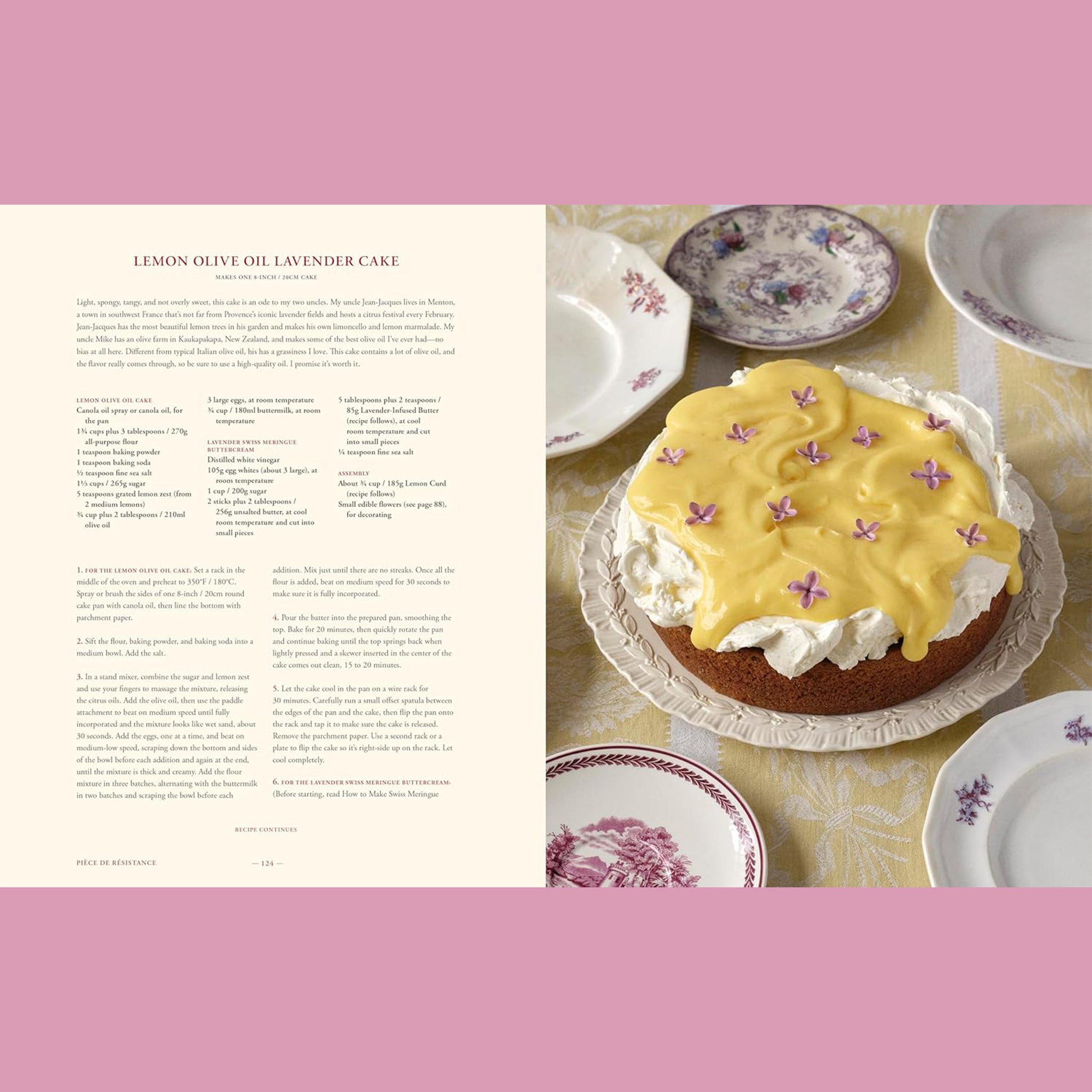 An open page of a book featuring recipe for Lemon Olive Oil Lavender Cake and a photo of the cake on the right with yellow frosting and purple flowers on it.

