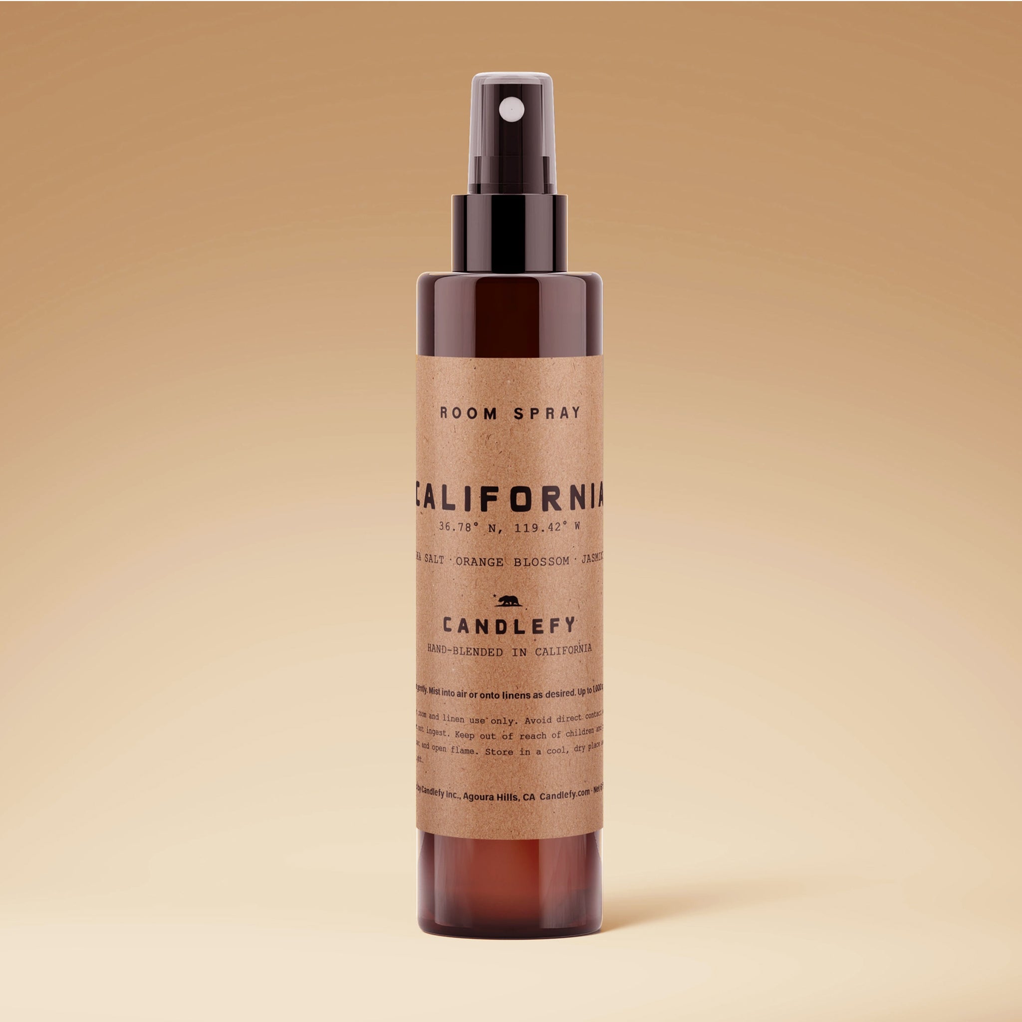 An amber glass bottle of room spray with black text that reads, 'California'. 