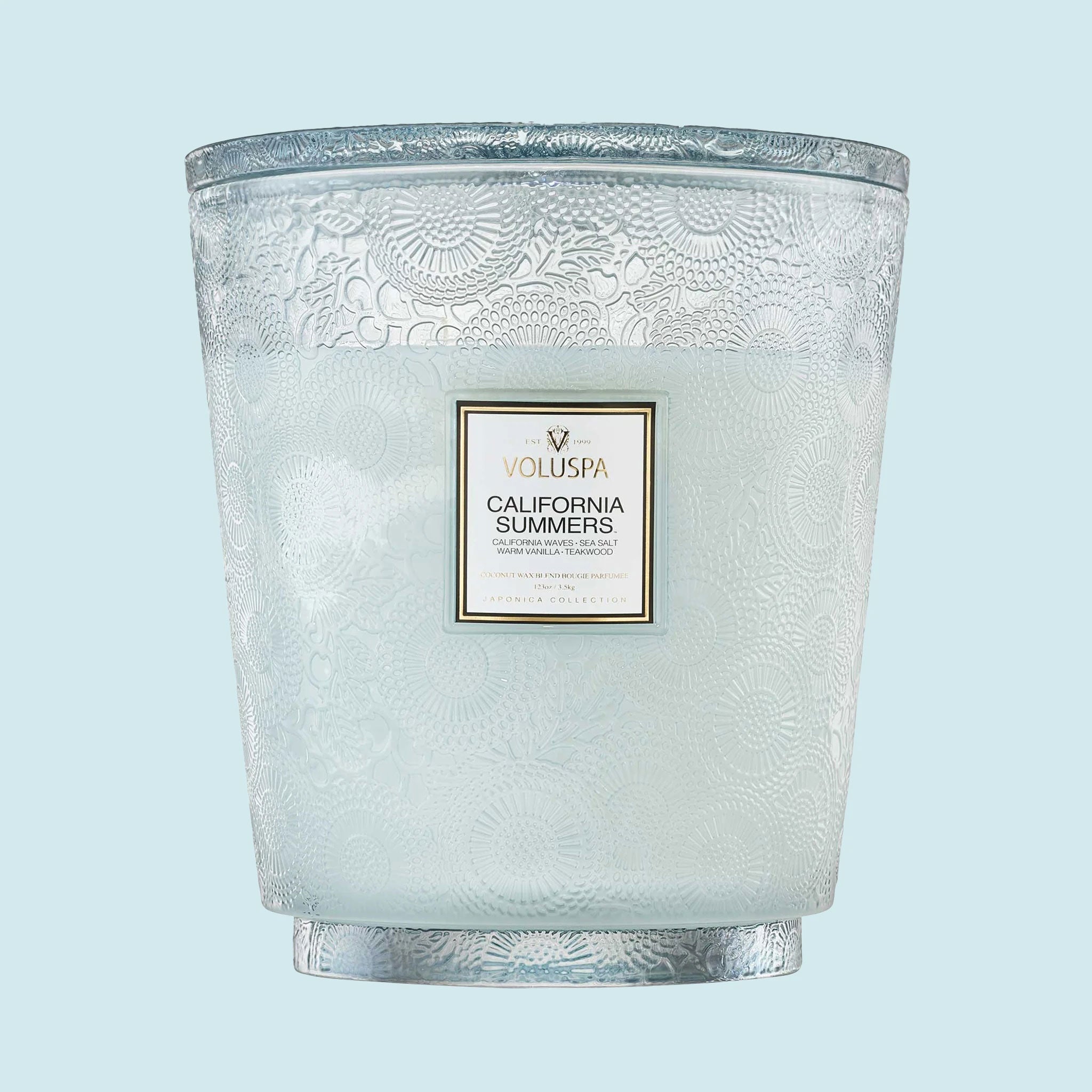 A large blue glass jar decorative jar candle. 