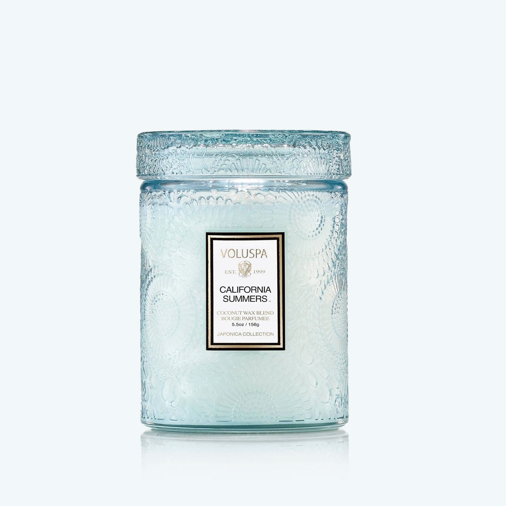 A light blue decorative jarred candle with a white label that reads, &#39;California Summers&#39;. 