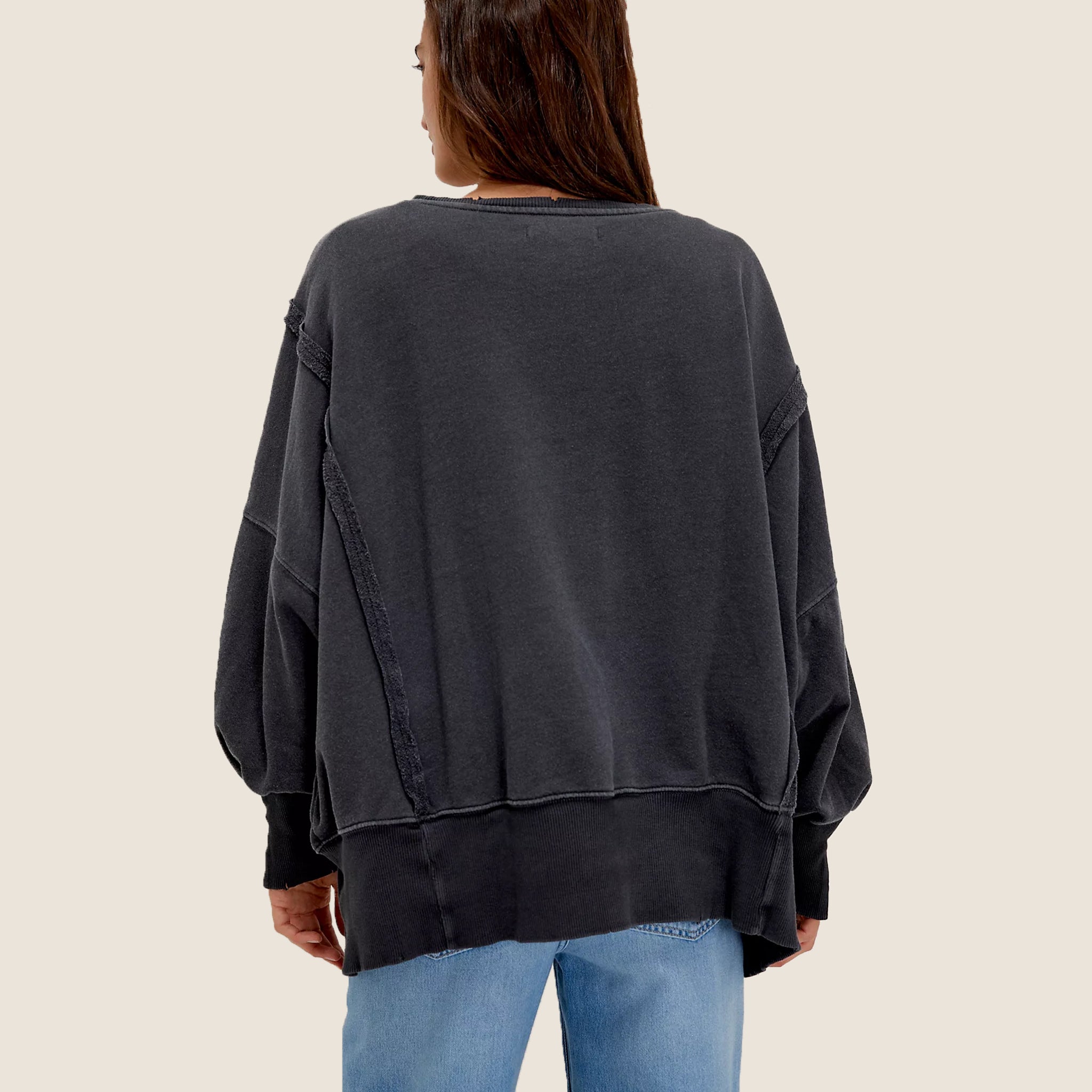 A grey slouchy sweatshirt with a white snake graphic on the front. 