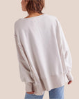 A white flowy top with a graphic of a brown highland cow and text underneath that reads, 'Highland cow'.