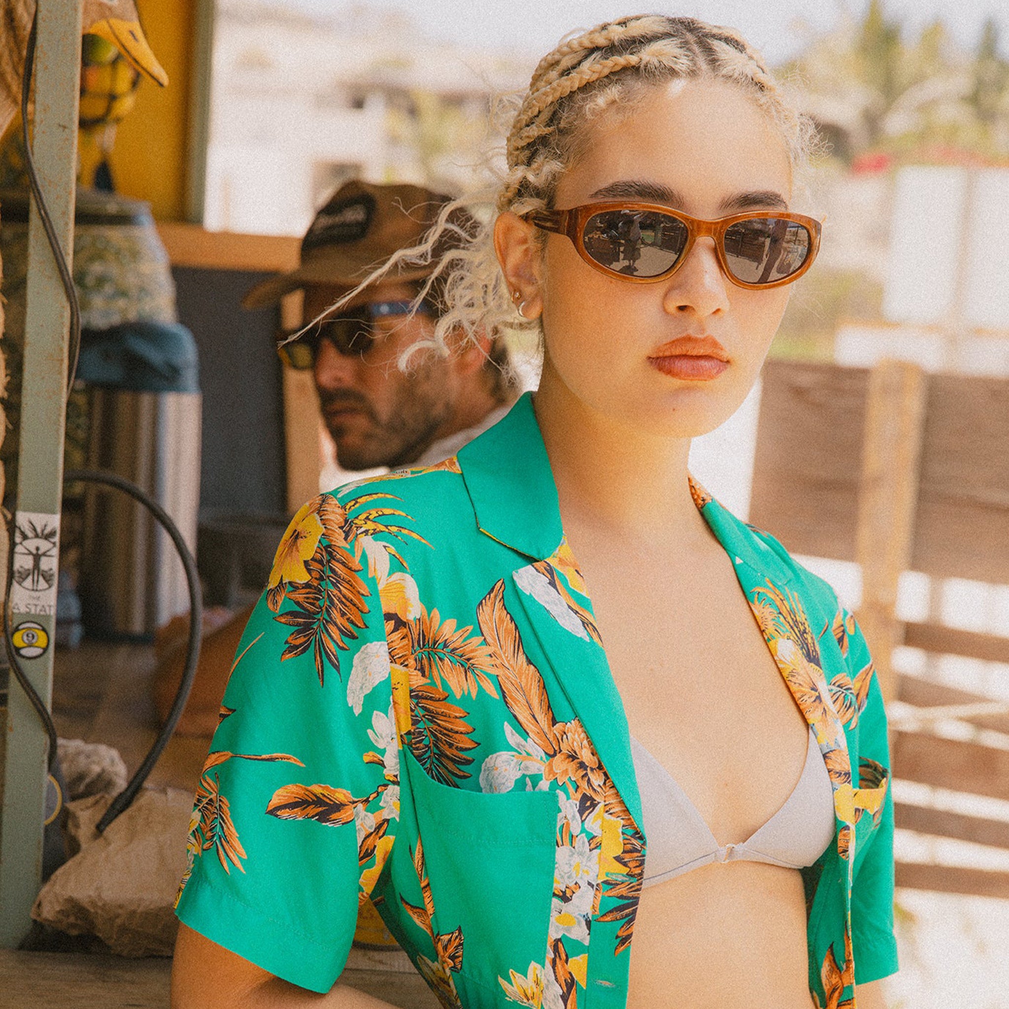 A teal and yellow tropical button up shirt. 