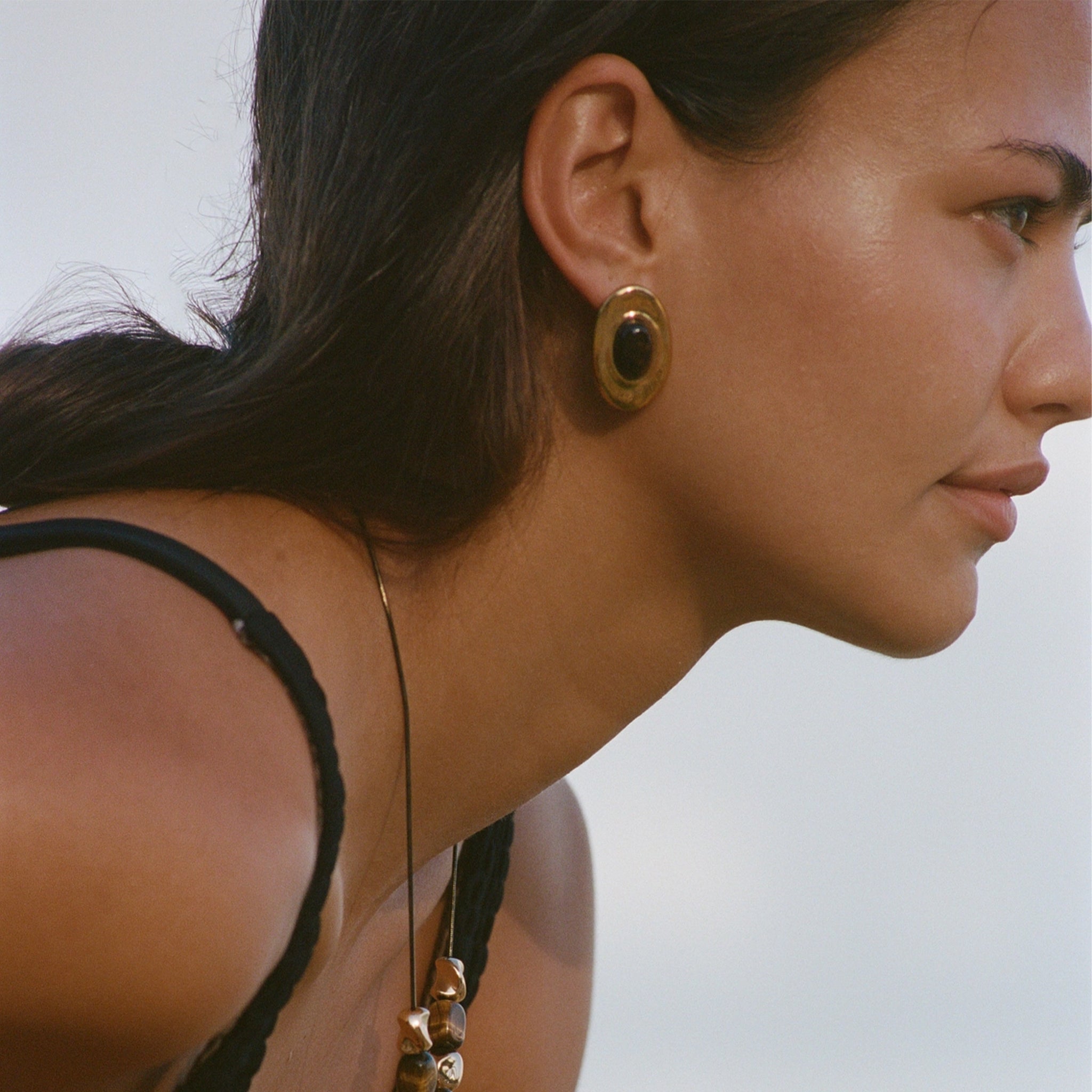 gold earrings with a dark center.