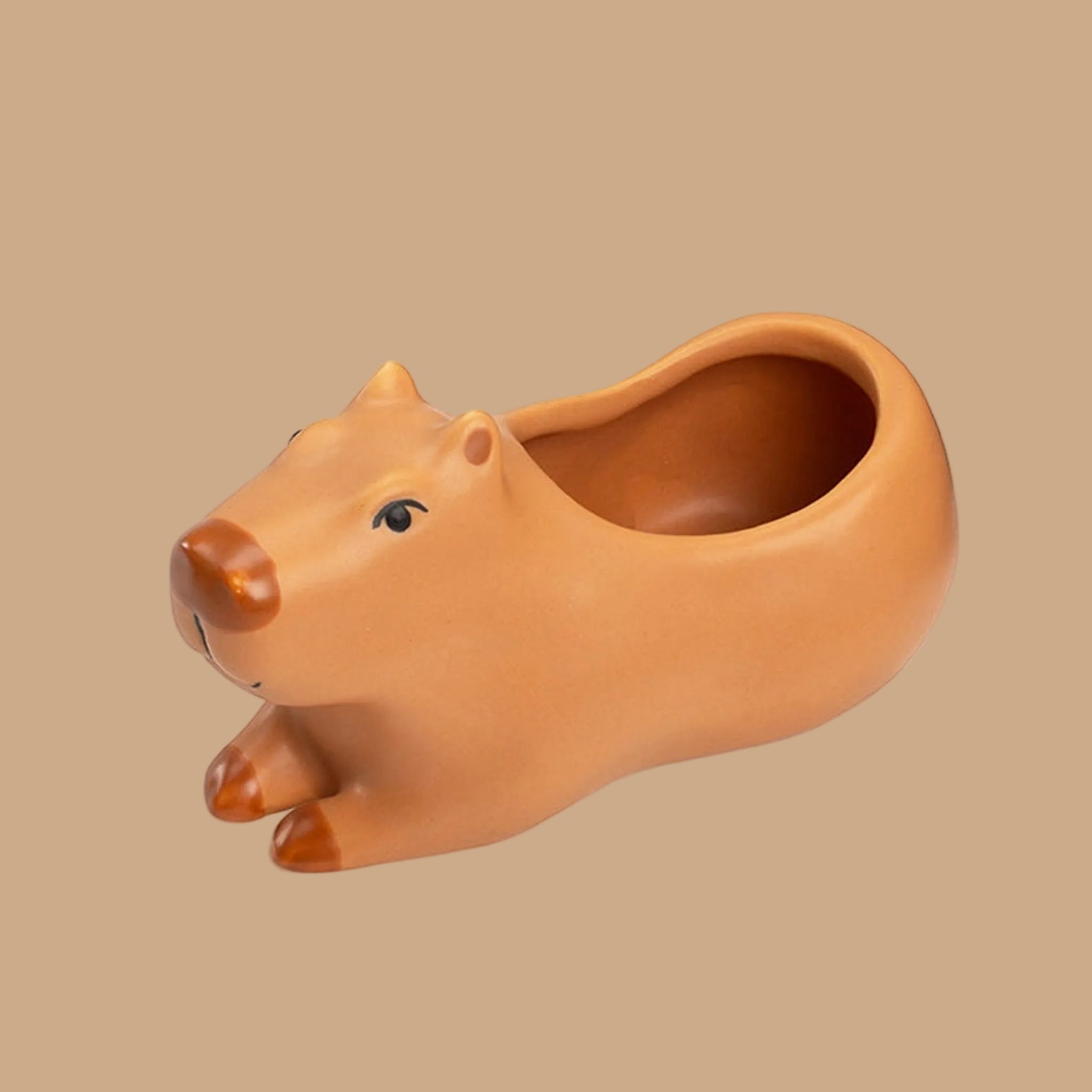 A porcelain capybara shaped planter. 