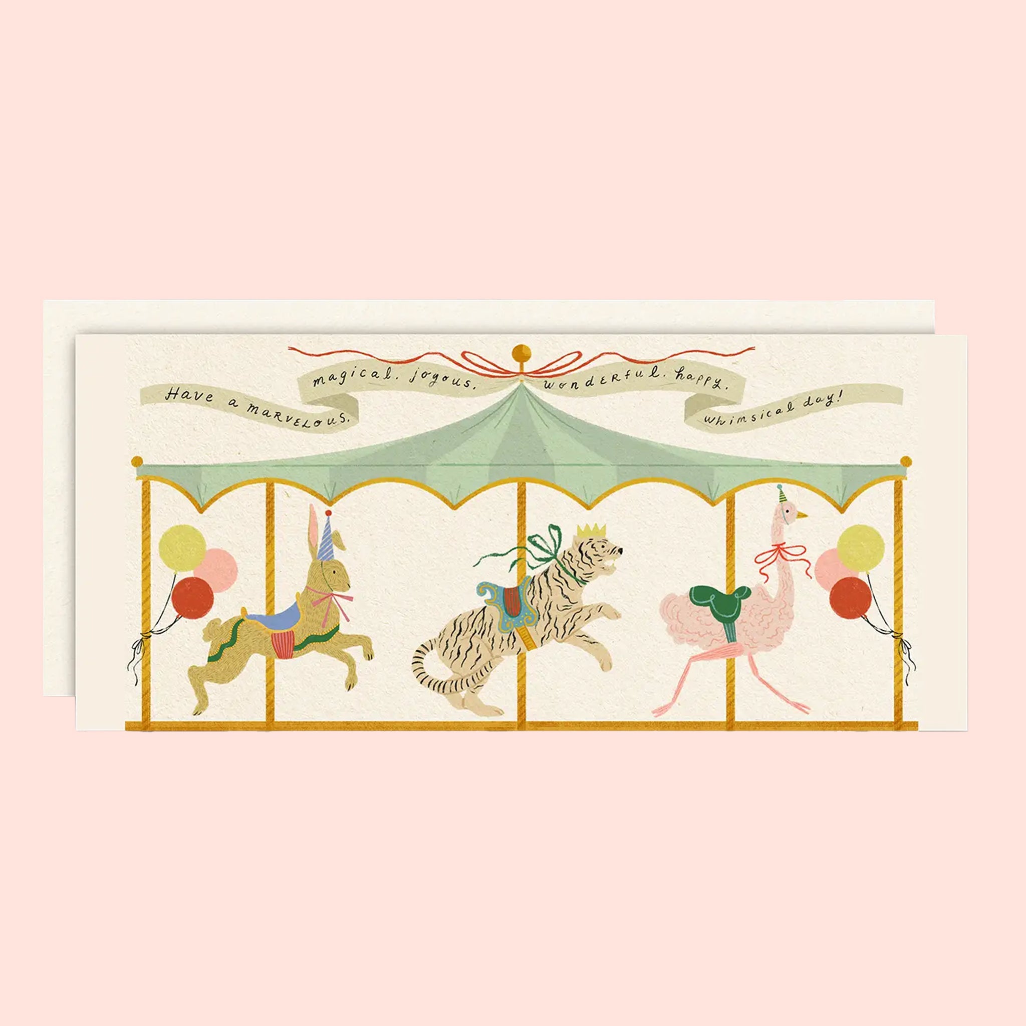 An ivory card with a graphic of a carousel and text above that reads, 'Have a marvelous, magical, joyous, wonderful, happy, whimsical day!'.