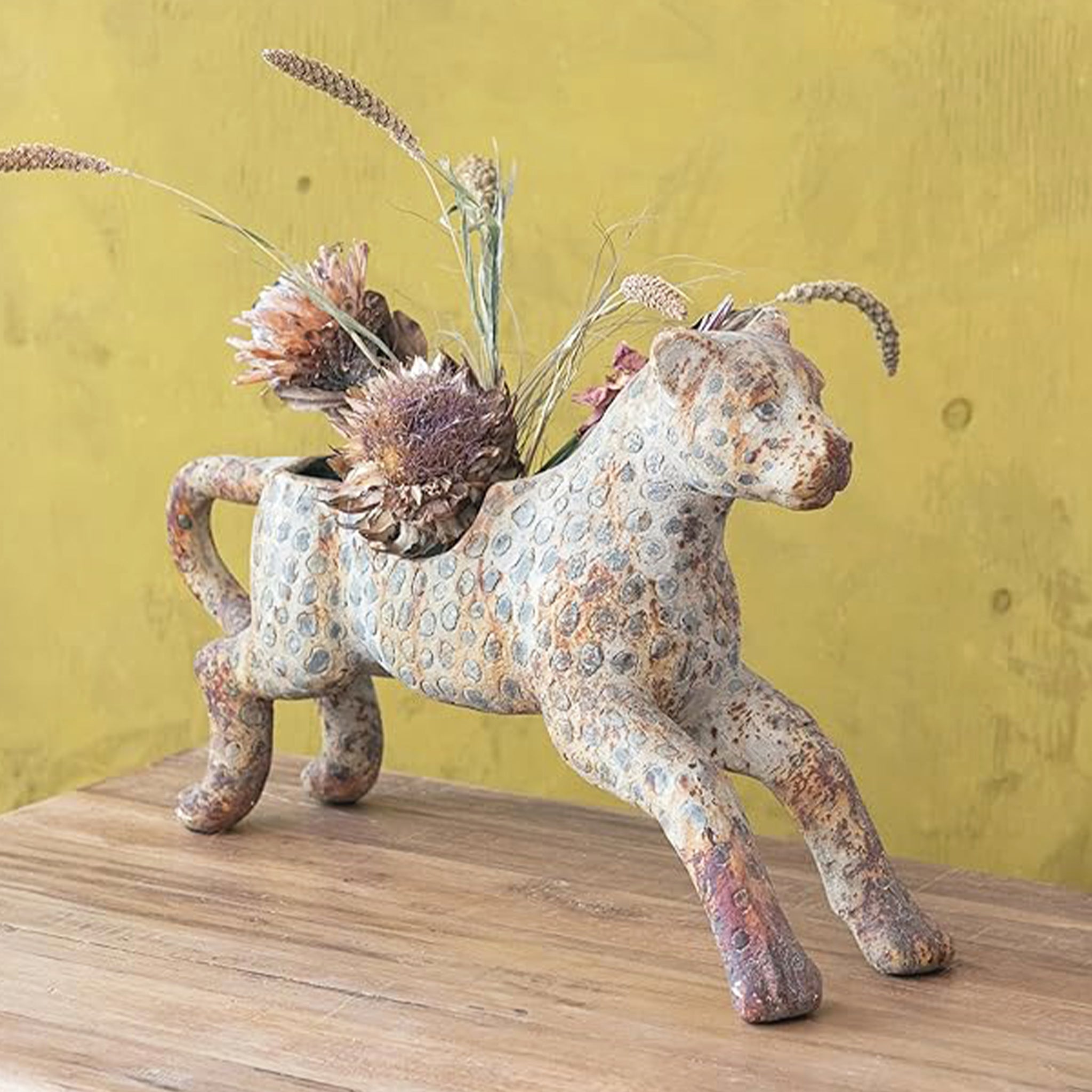 A leopard shaped rustic planter. 