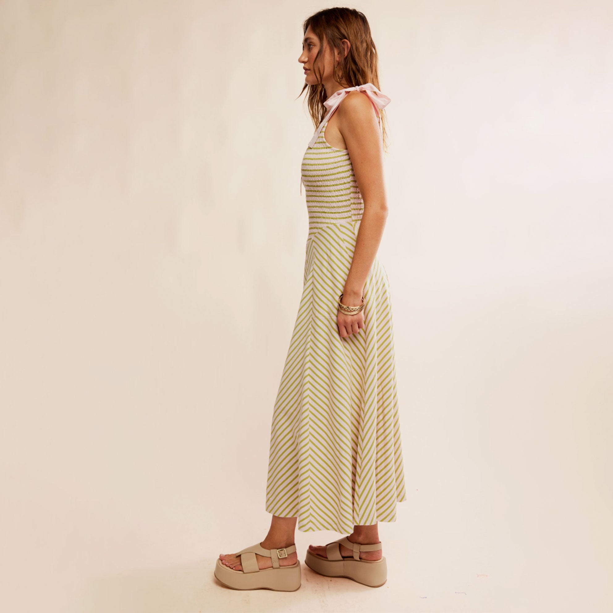 A green and cream striped dress with tie strap details. 