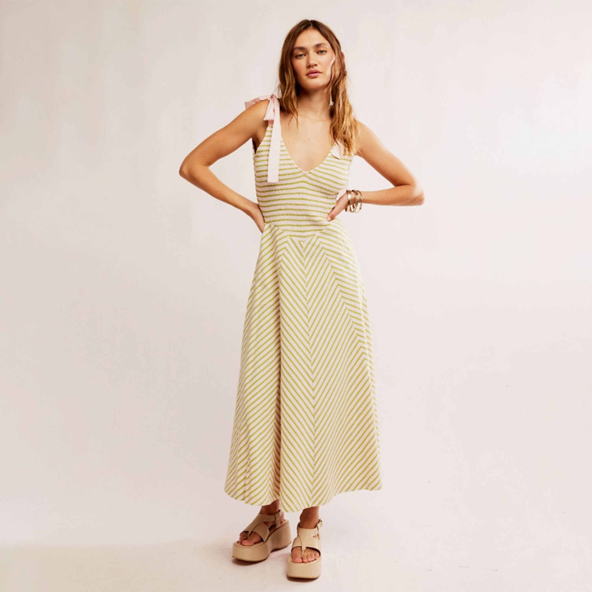 A green and cream striped dress with tie strap details. 