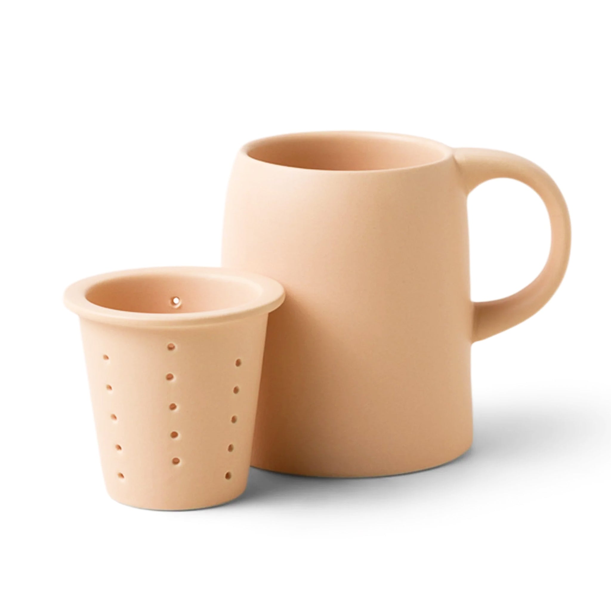 On a white background is a ceramic mug with an infuser cup to insert inside the rim of the mug. 