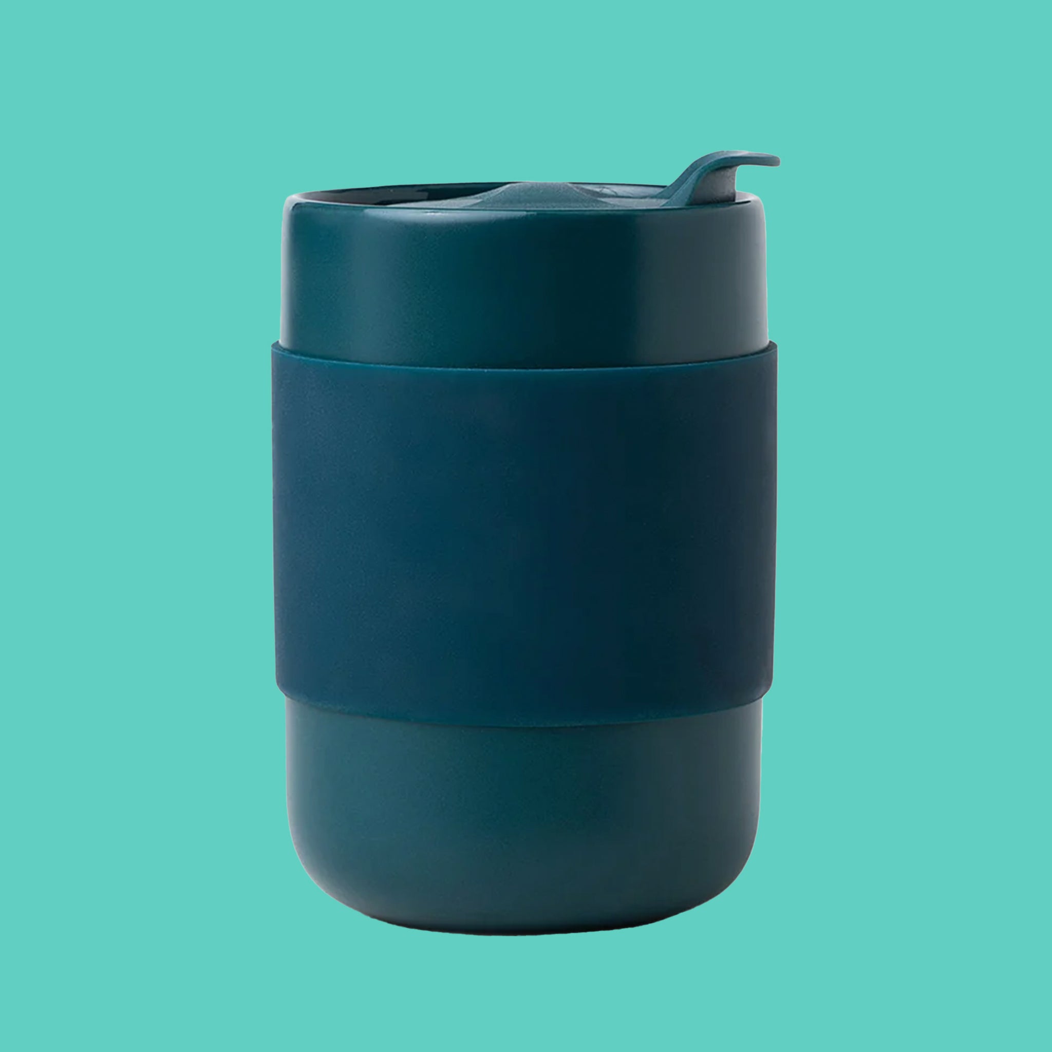 On a teal background is a dark teal tumbler with a silicone sleeve. 