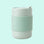 On a mint green background is a mint green ceramic tumbler with a silicone sleeve. 
